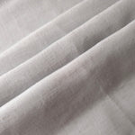 Soft pearl grey linen viscose plain fabric texture, showing the soft, flowy hand of the weave.