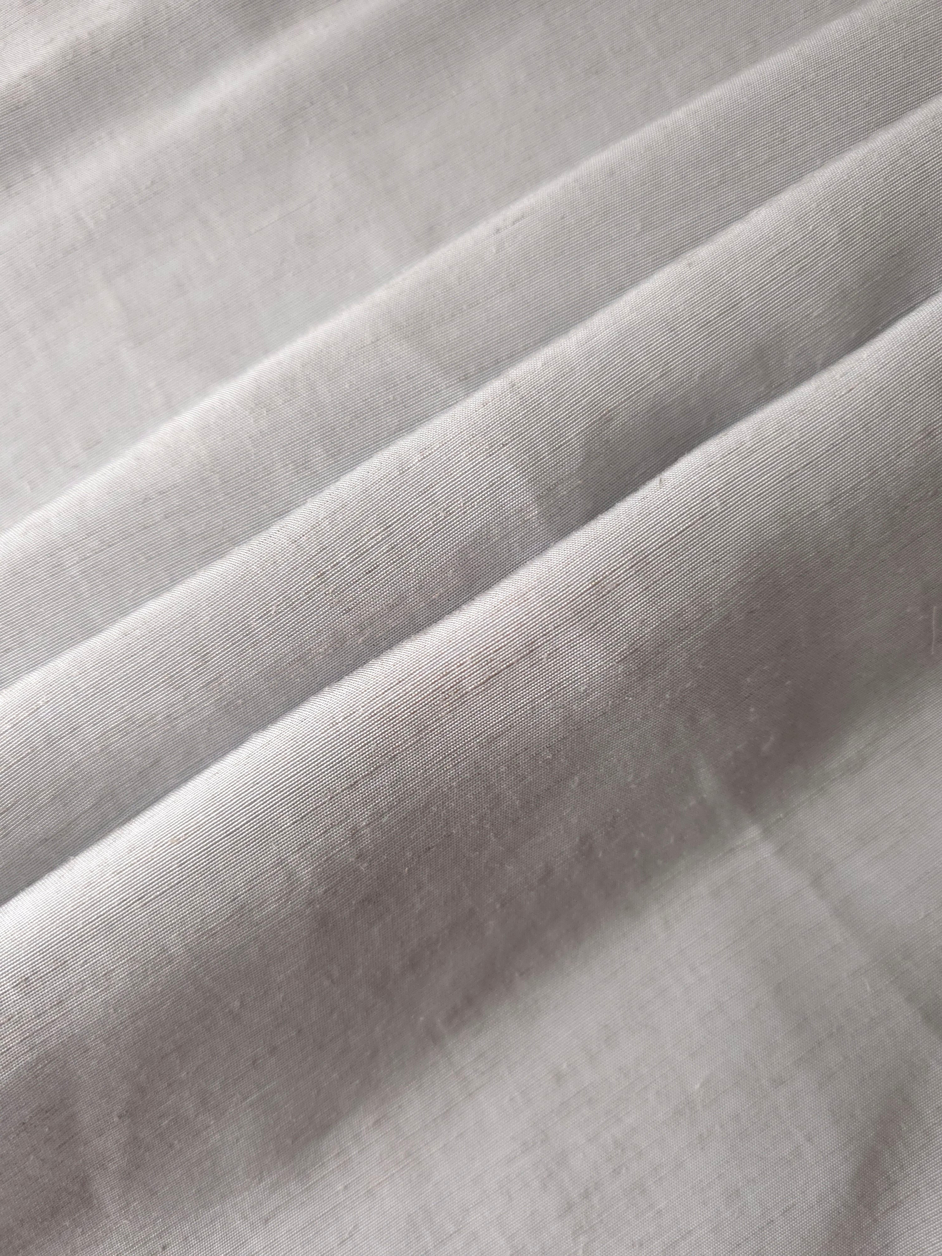 Soft pearl grey linen viscose plain fabric texture, showing the soft, flowy hand of the weave.