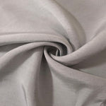 Folded soft pearl grey linen viscose plain fabric, illustrating its lightweight feel for garment sewing.