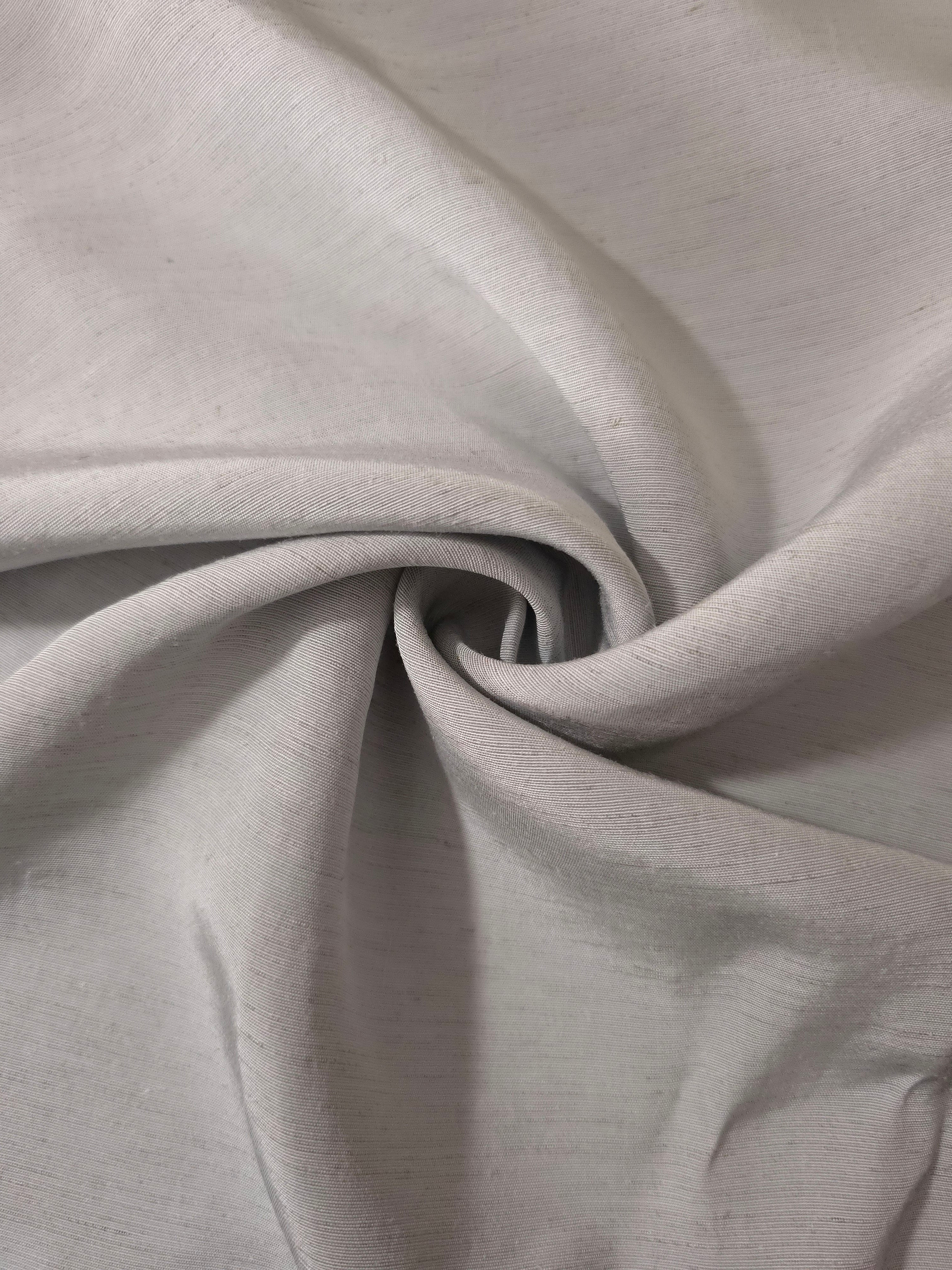 Folded soft pearl grey linen viscose plain fabric, illustrating its lightweight feel for garment sewing.