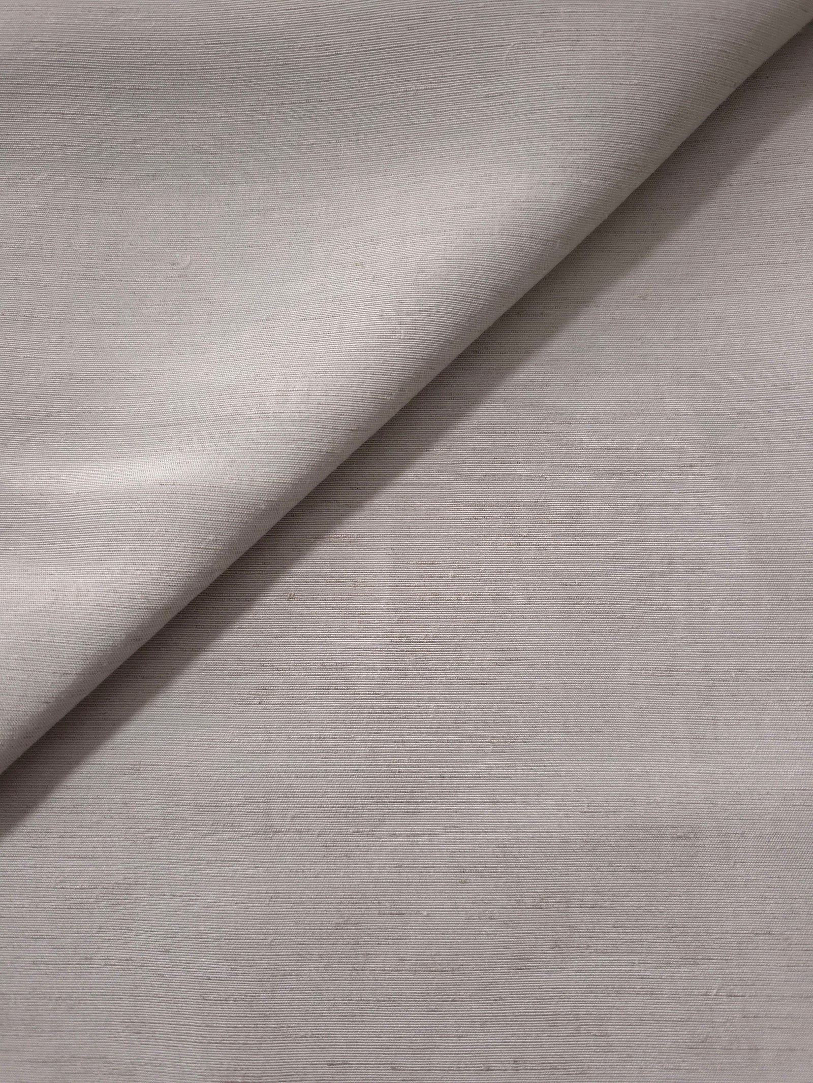 Macro detail of soft pearl grey linen viscose plain fabric, highlighting the plain weave's natural grain.