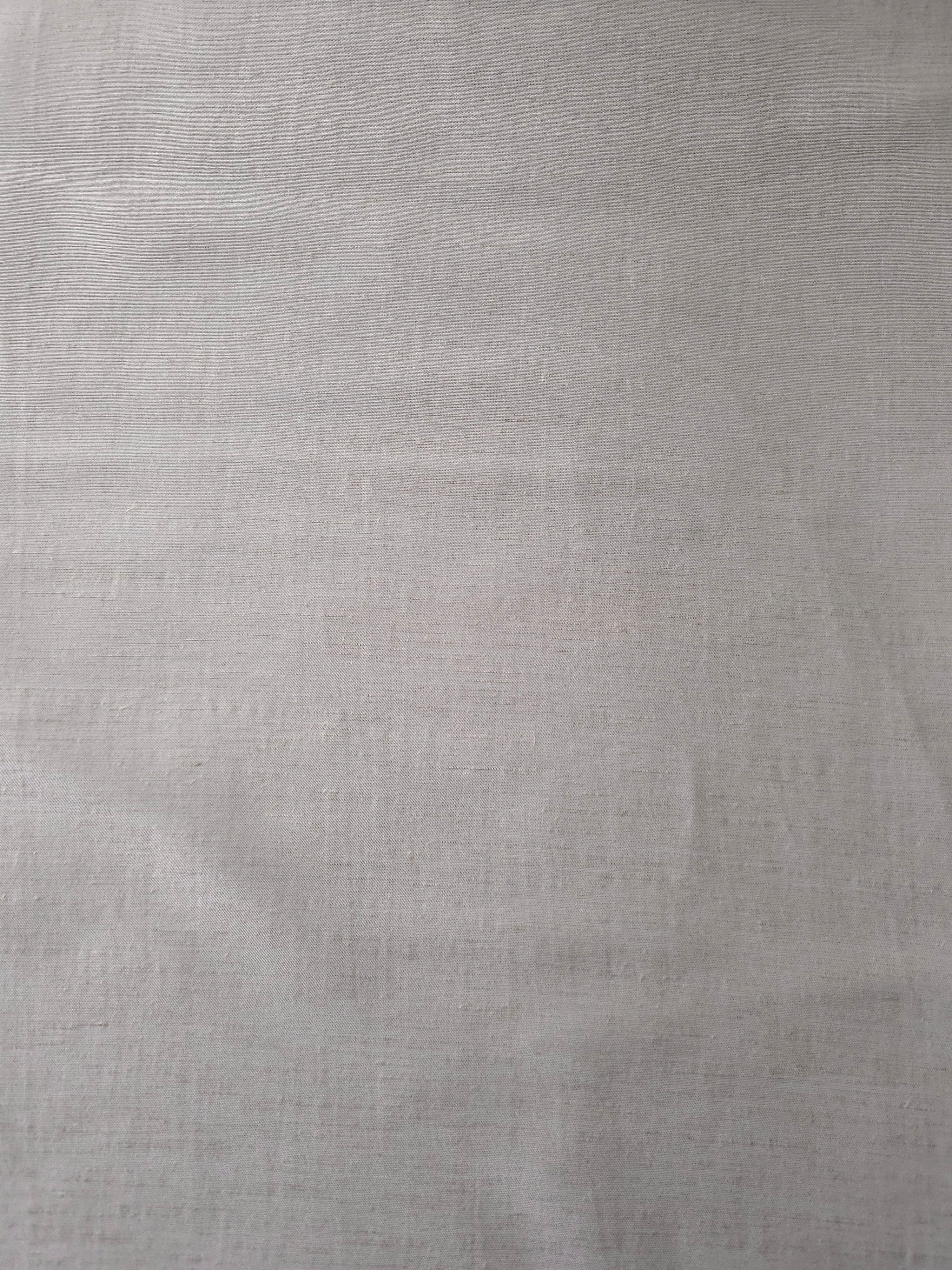 Draped view of soft pearl grey linen viscose plain fabric, showing the fluid drape used for dresses and skirts.