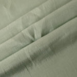 Texture view of muted sage grey linen viscose plain fabric highlighting its flowy, breathable finish.