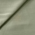 Close-up of muted sage grey linen viscose plain fabric showing its natural woven texture.