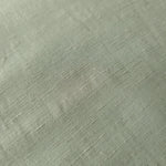 Muted sage grey linen viscose plain fabric draped to show its soft structure, ideal for dressmaking.