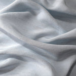 Close-up of cool grey-blue linen viscose plain fabric showing its natural woven texture.