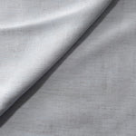 Cool grey-blue linen viscose plain fabric draped to show its soft structure, ideal for dressmaking.