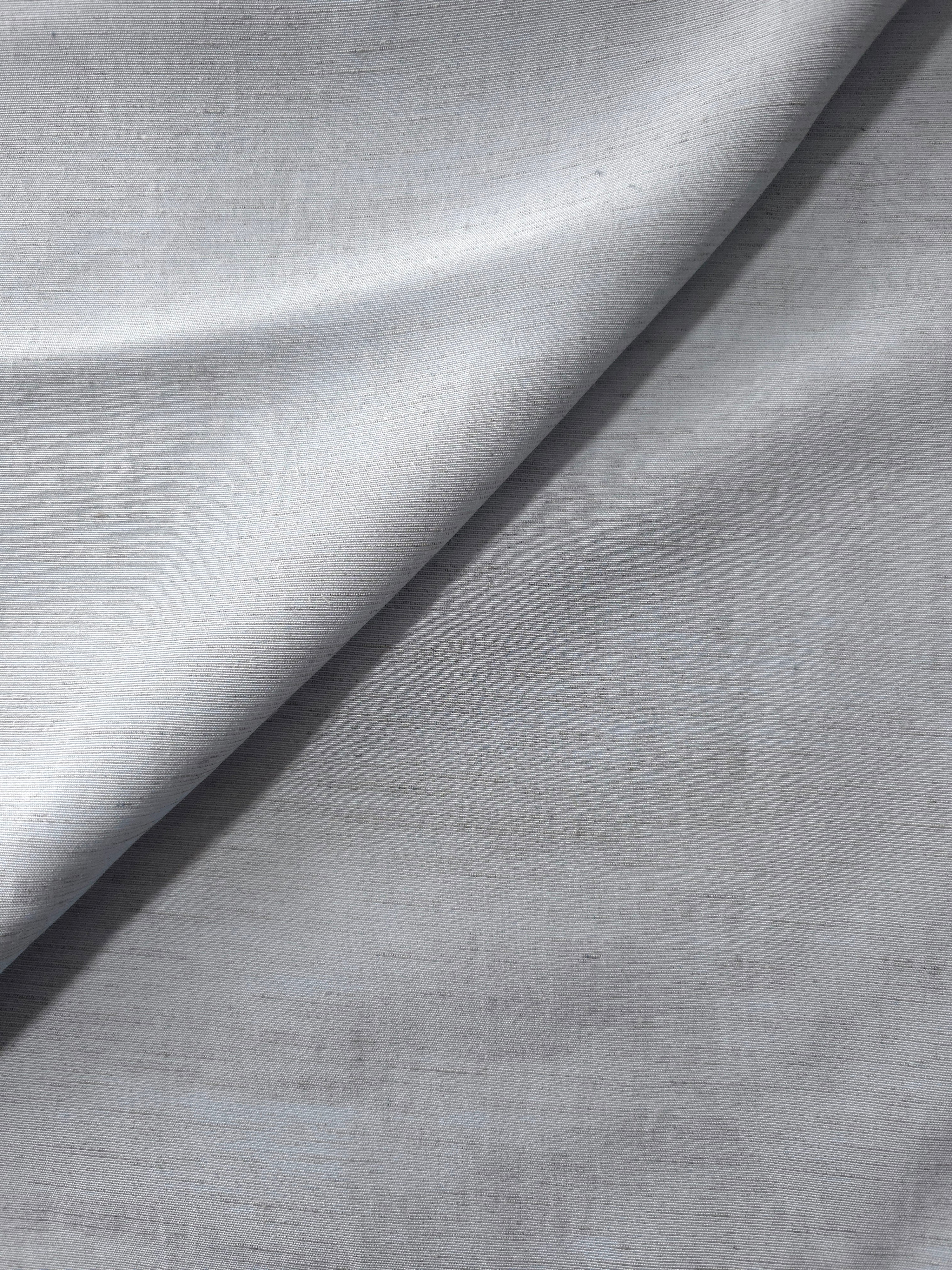Cool grey-blue linen viscose plain fabric draped to show its soft structure, ideal for dressmaking.