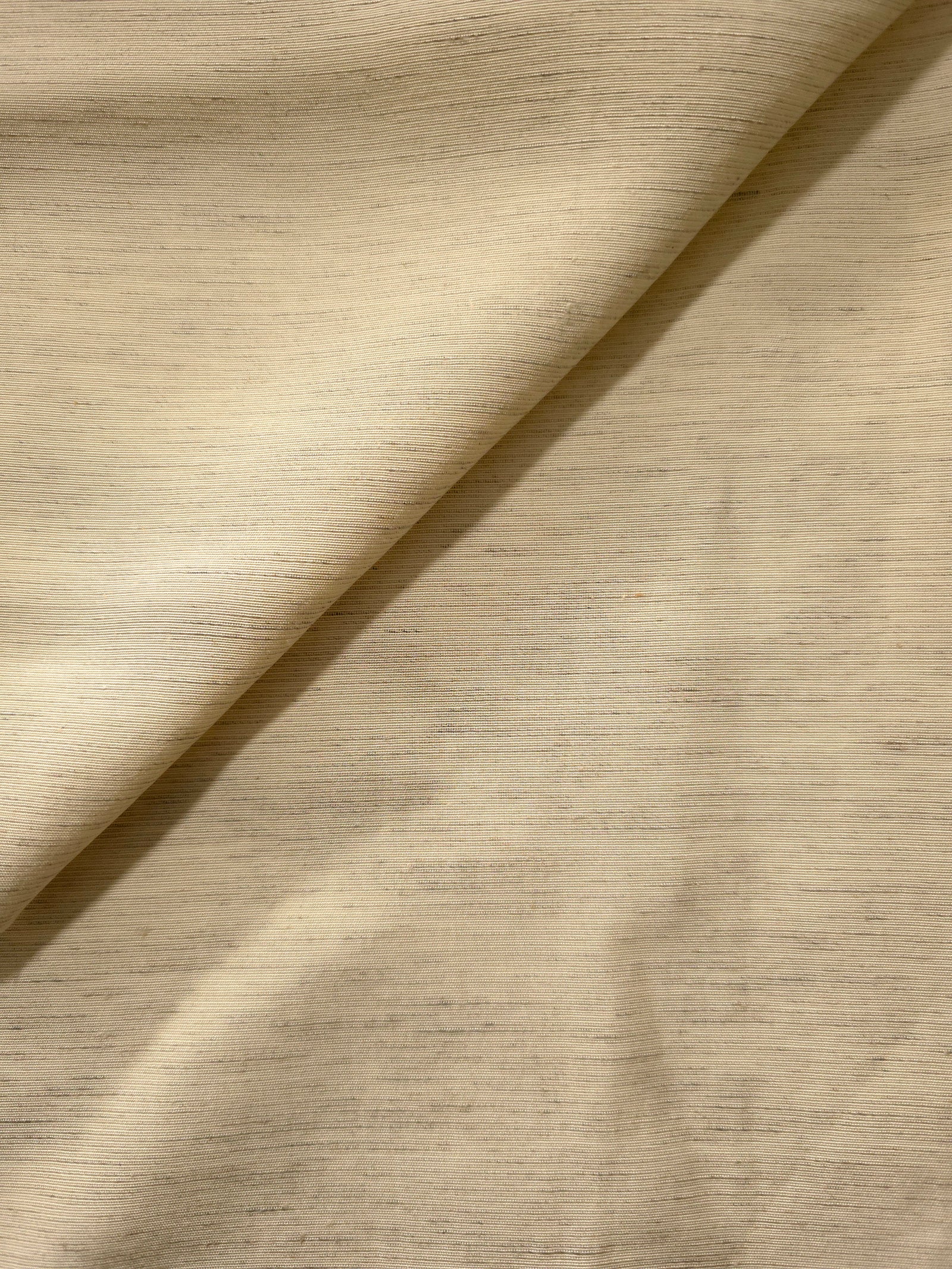 Soft cream linen viscose plain fabric with a smooth, breathable weave suited for warm-weather apparel.