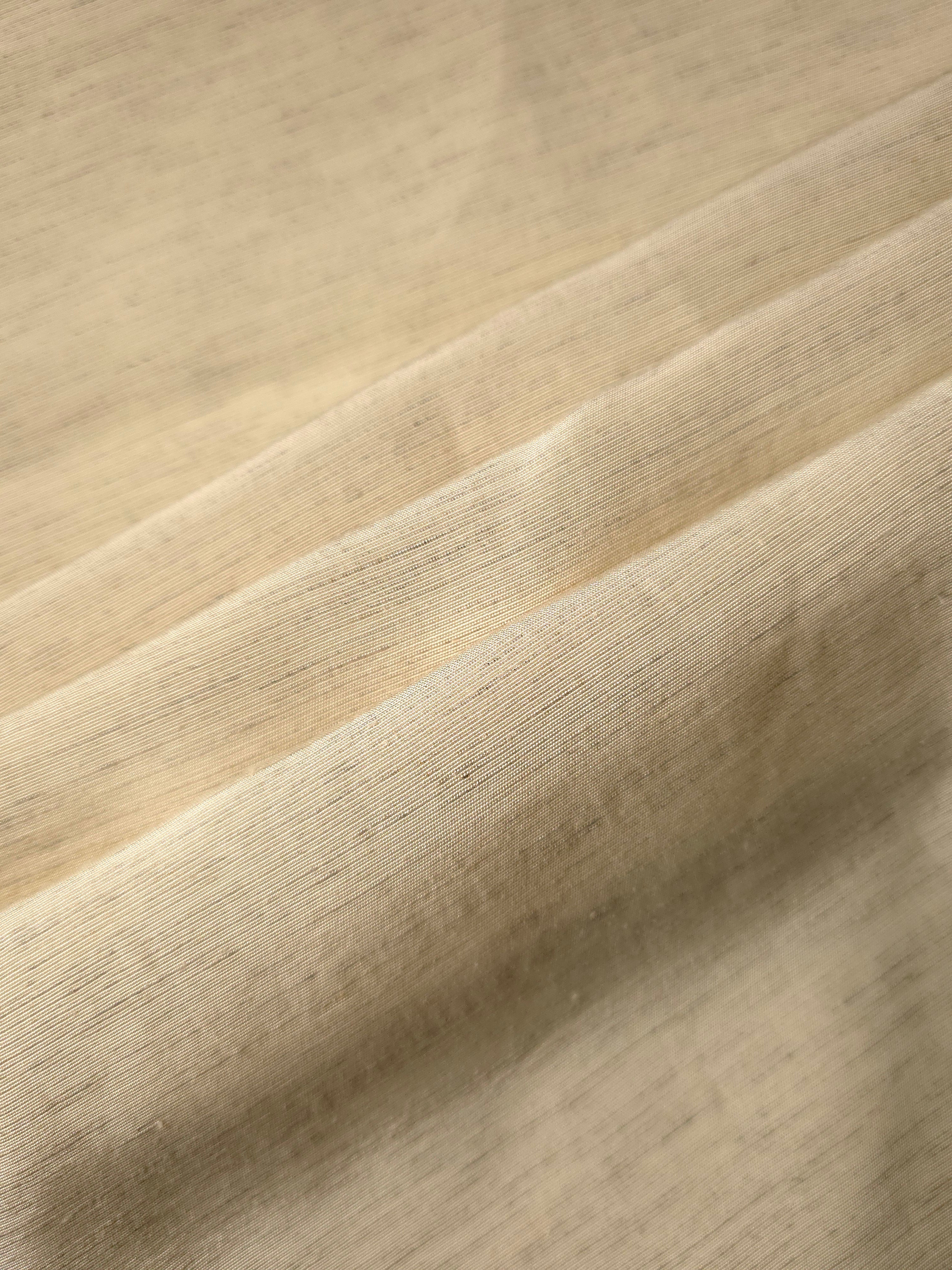 Texture view of soft cream linen viscose plain fabric highlighting its flowy, breathable finish.