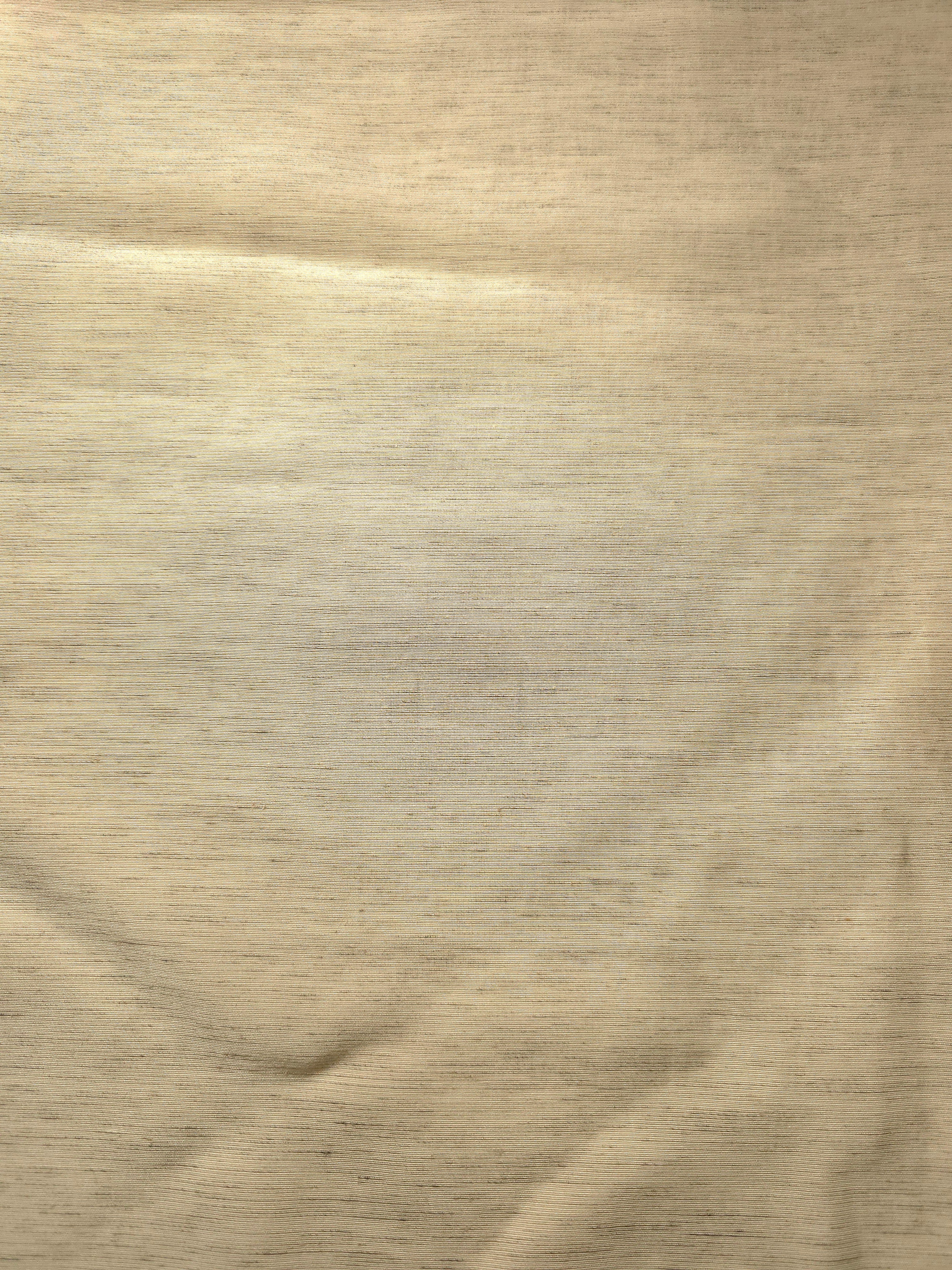 Close-up of soft cream linen viscose plain fabric showing its natural woven texture.