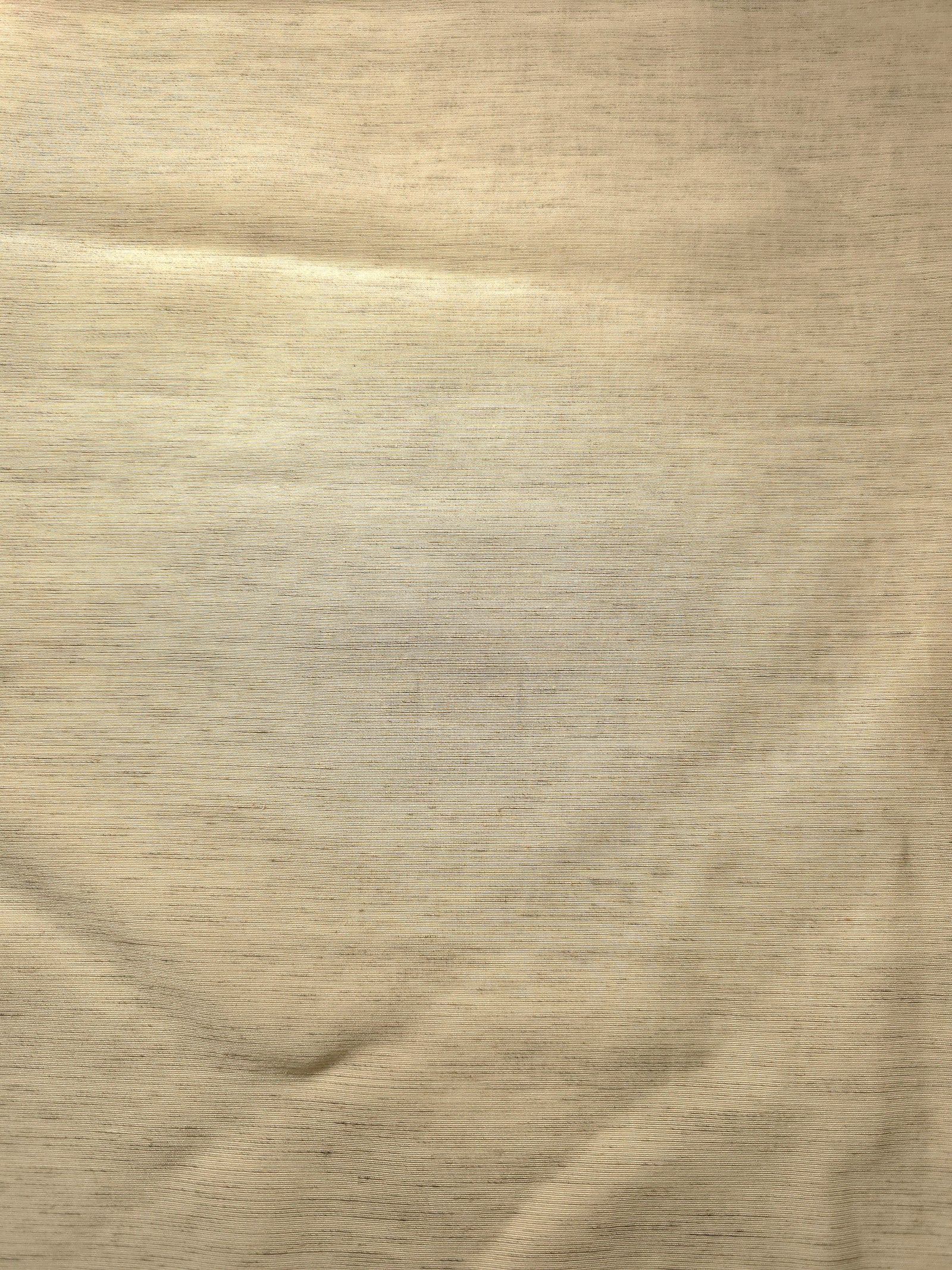 Close-up of soft cream linen viscose plain fabric showing its natural woven texture.