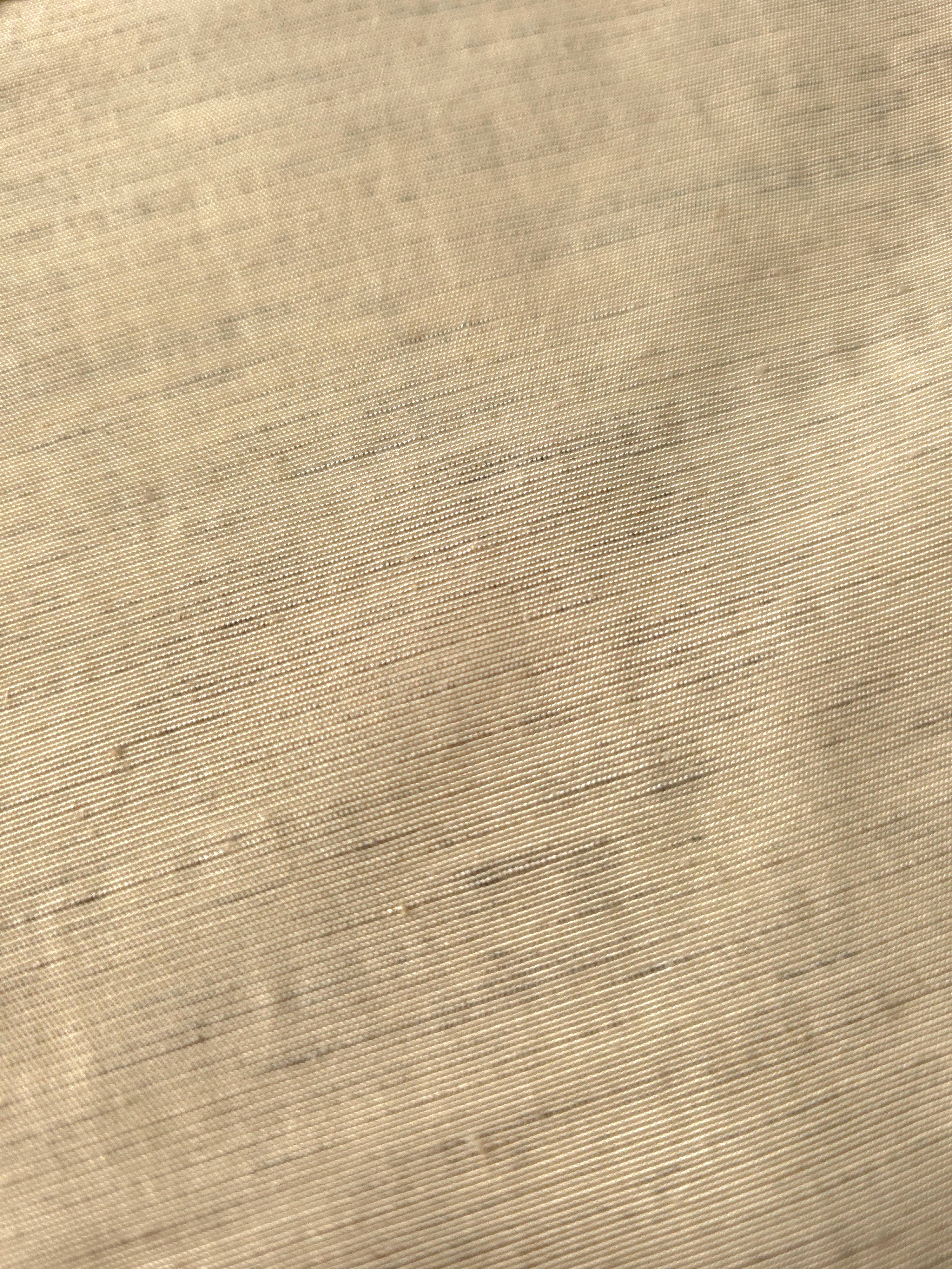 Soft cream linen viscose plain fabric draped to show its soft structure, ideal for dressmaking.