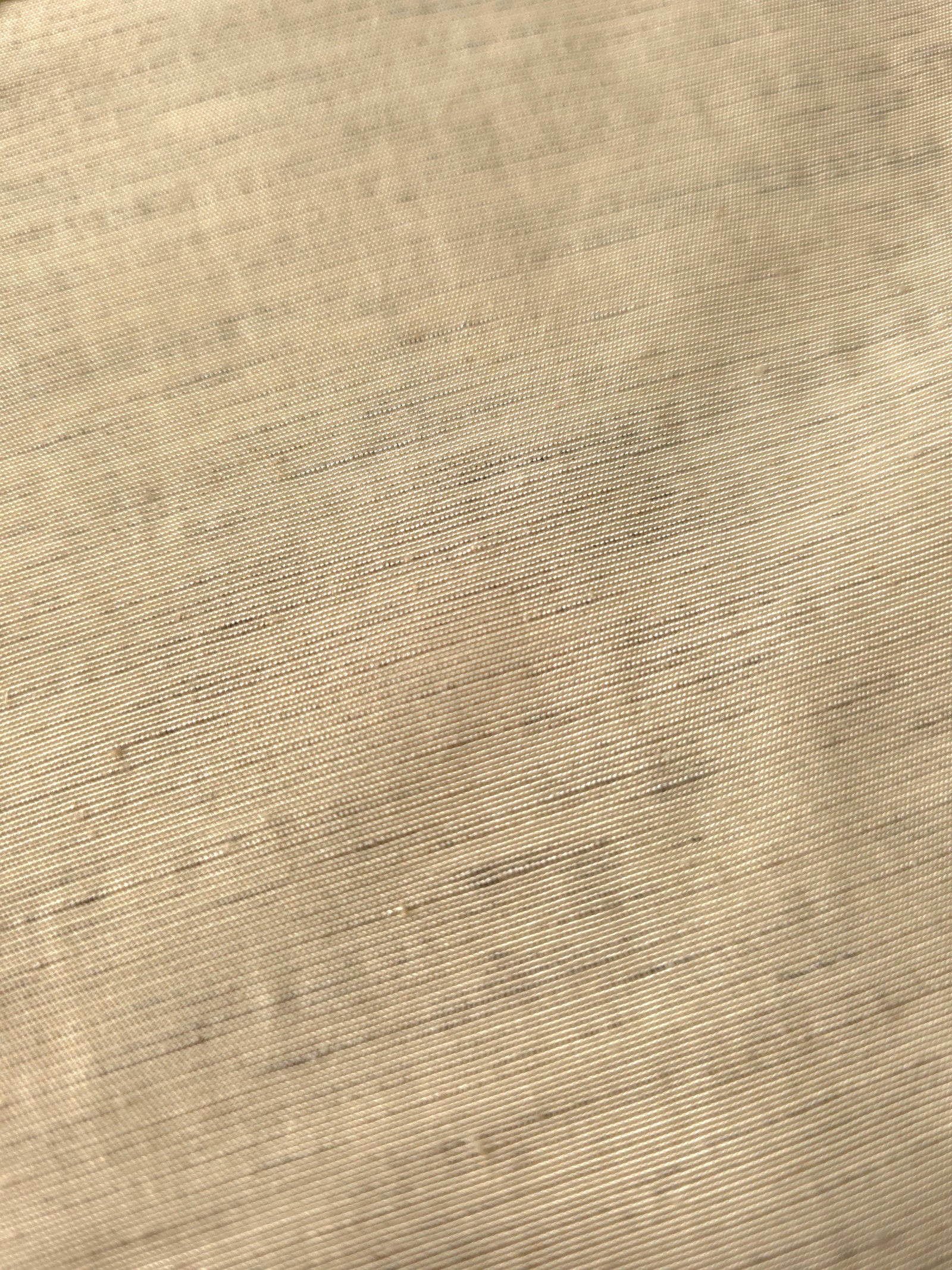 Soft cream linen viscose plain fabric draped to show its soft structure, ideal for dressmaking.