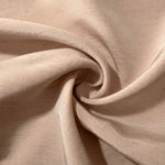 Warm sandy beige linen viscose plain fabric styled for modestwear, with a matte, soft-touch finish.
