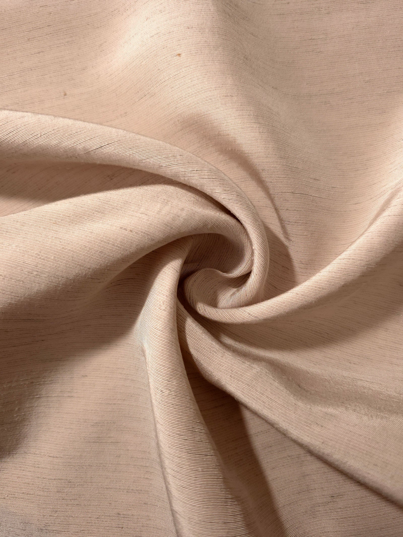 Warm sandy beige linen viscose plain fabric styled for modestwear, with a matte, soft-touch finish.