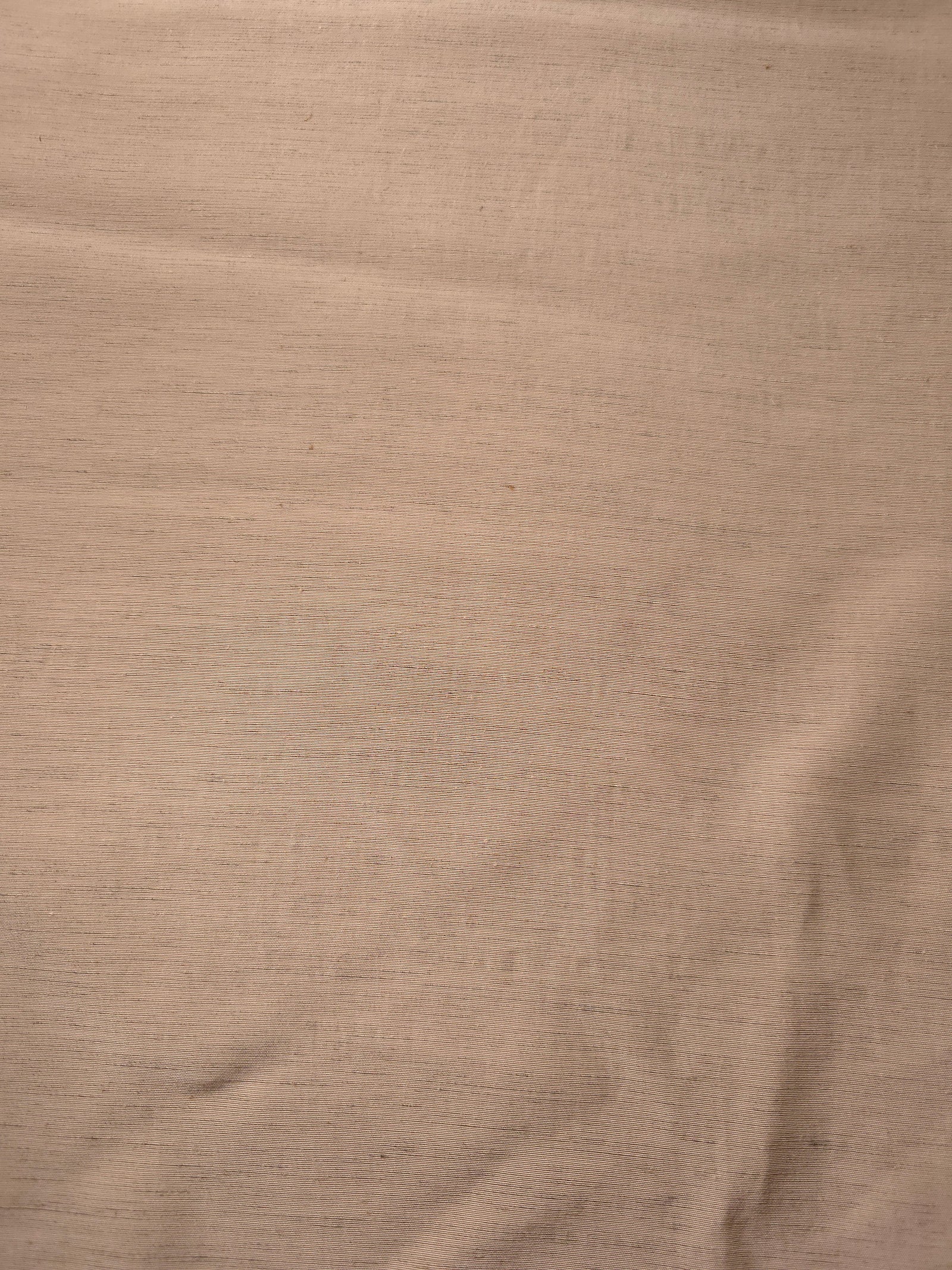 Warm sandy beige linen viscose plain fabric draped to show its soft structure, ideal for dressmaking.
