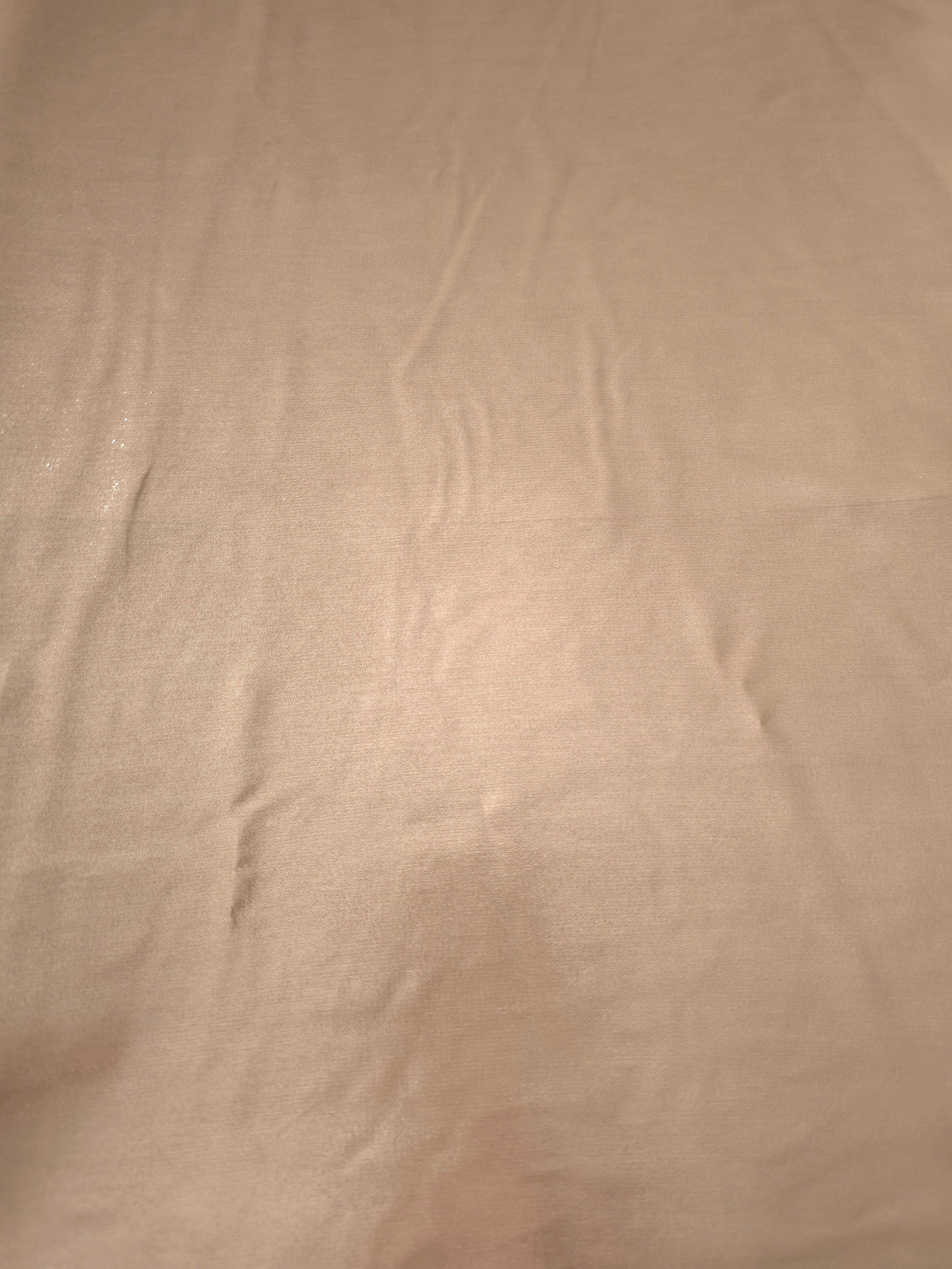 Champagne beige fabric overview view of liquid metallic shimmer chiffon fabric, highlighting fluid folds and reflective surface