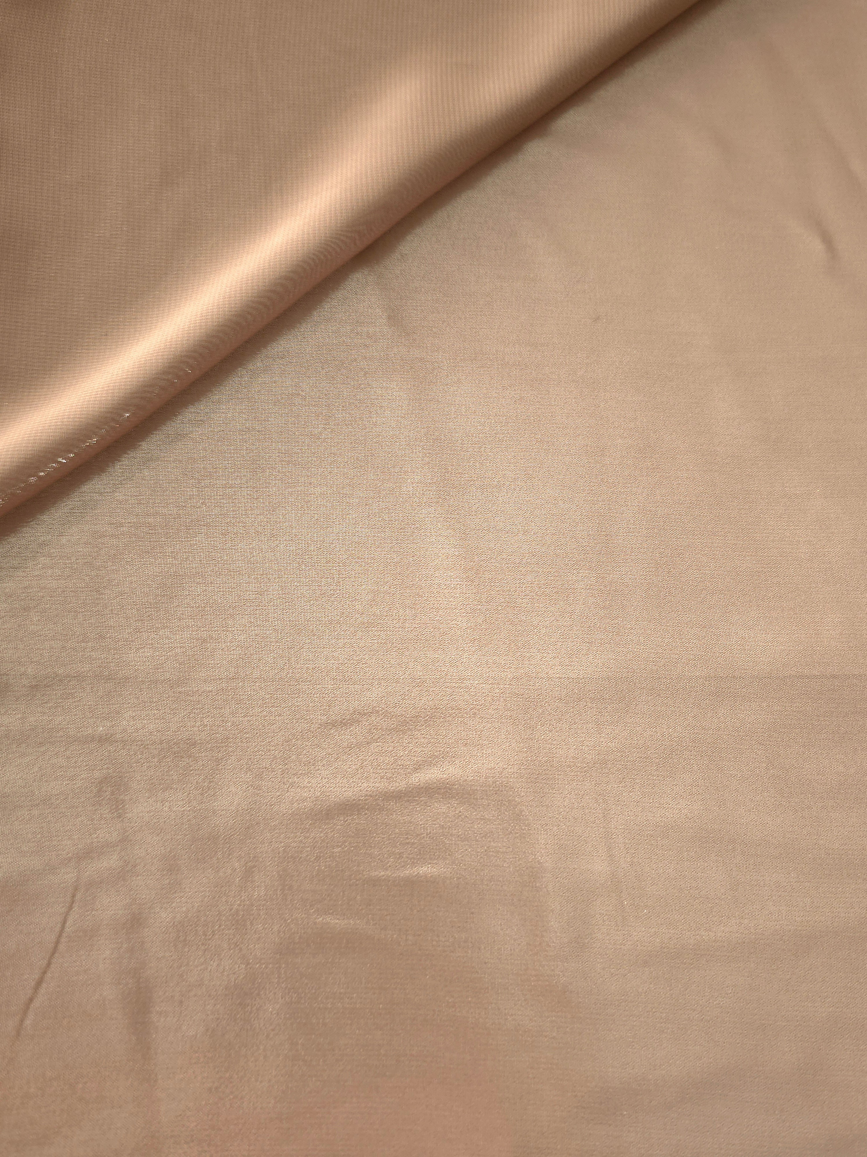 Champagne beige soft draping view of liquid metallic shimmer chiffon fabric, highlighting fluid folds and reflective surface