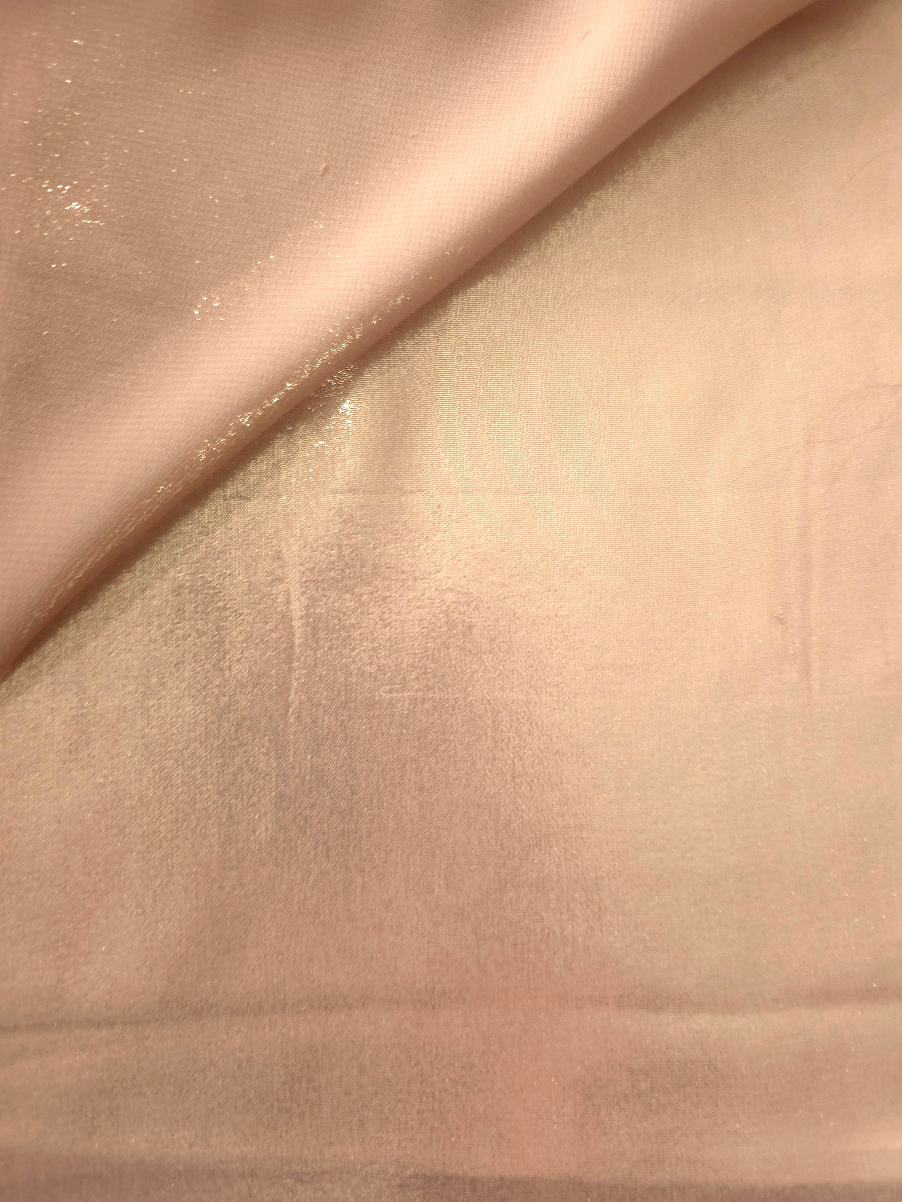 Cream gold soft draping view of liquid metallic shimmer chiffon fabric, highlighting fluid folds and reflective surface