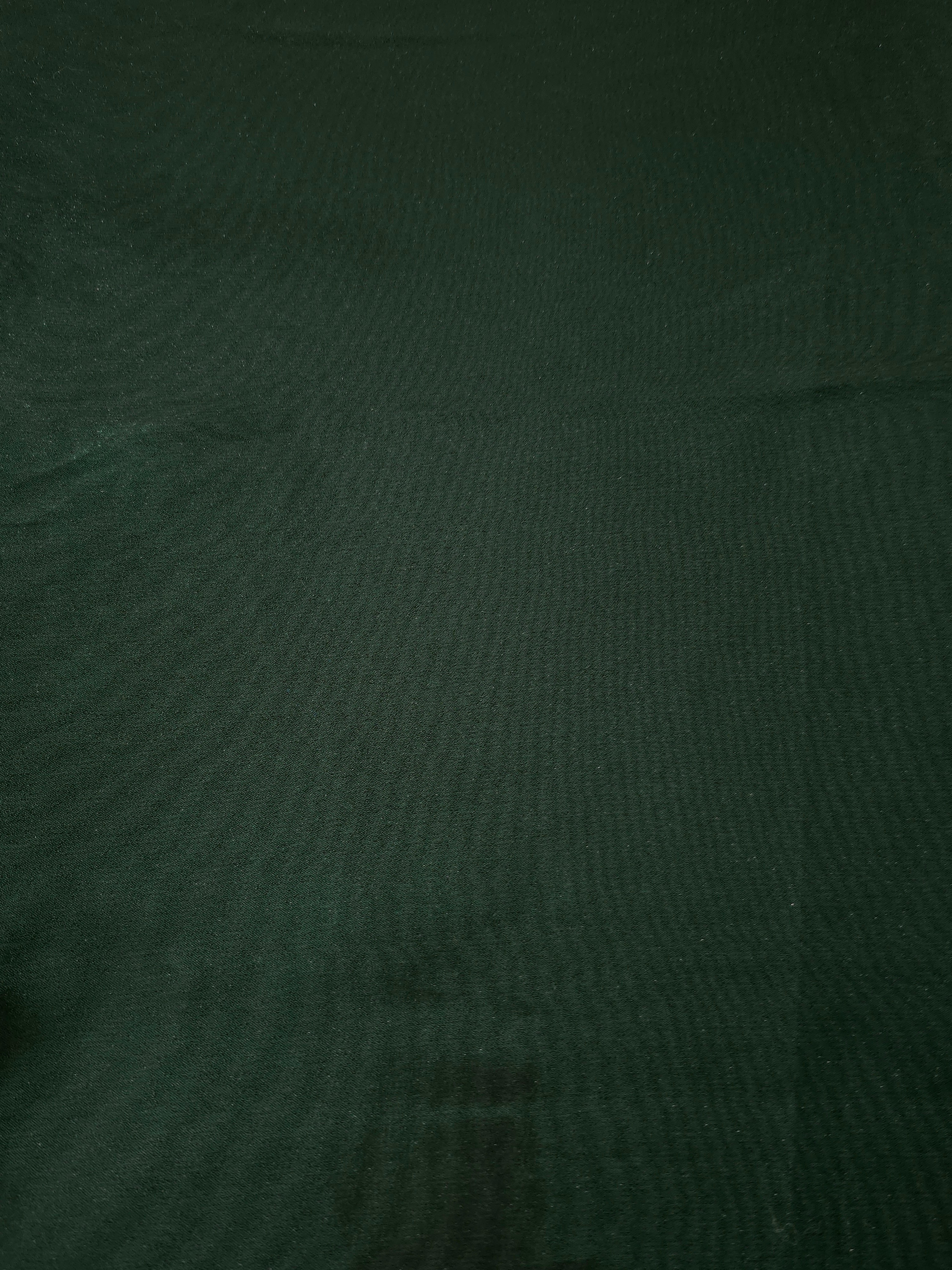 Deep forest fabric overview view of liquid metallic shimmer chiffon fabric, highlighting fluid folds and reflective surface