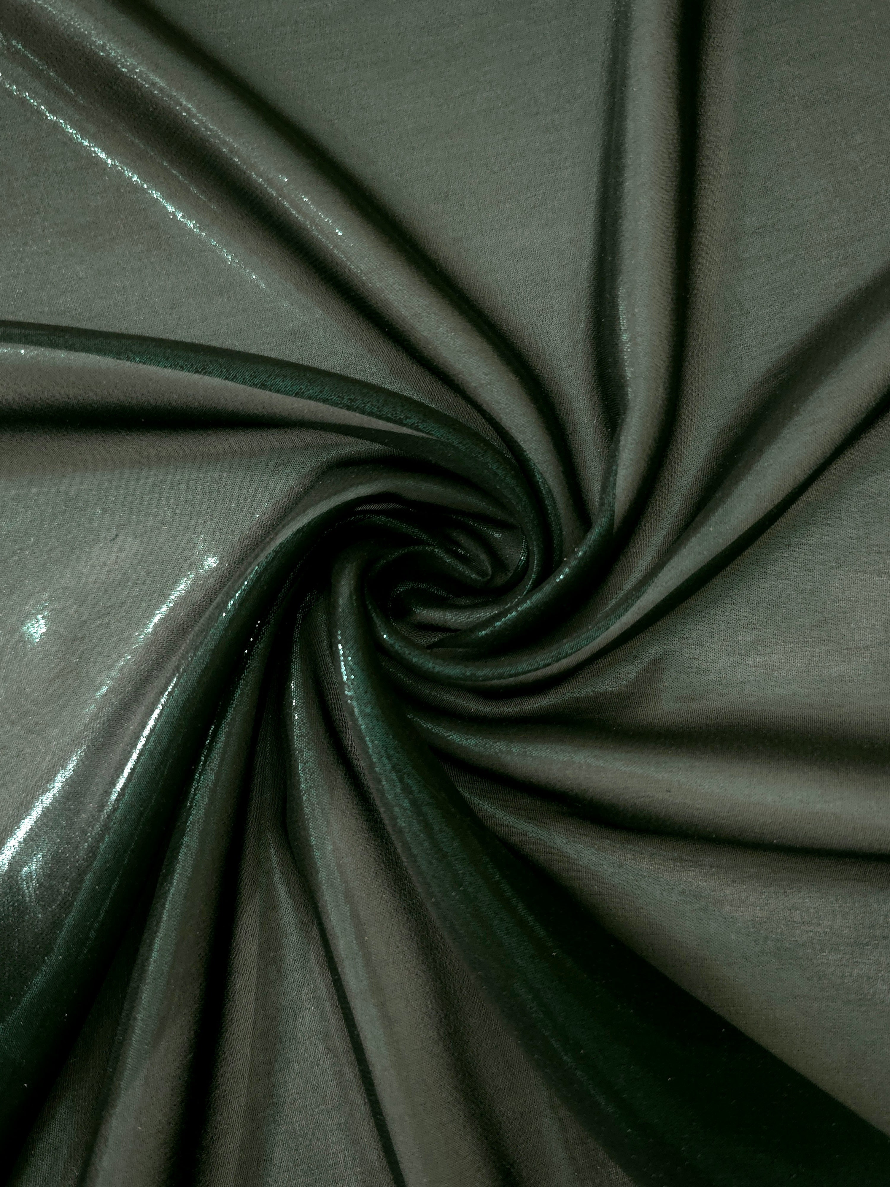 Deep forest shimmer close up view of liquid metallic shimmer chiffon fabric, highlighting fluid folds and reflective surface
