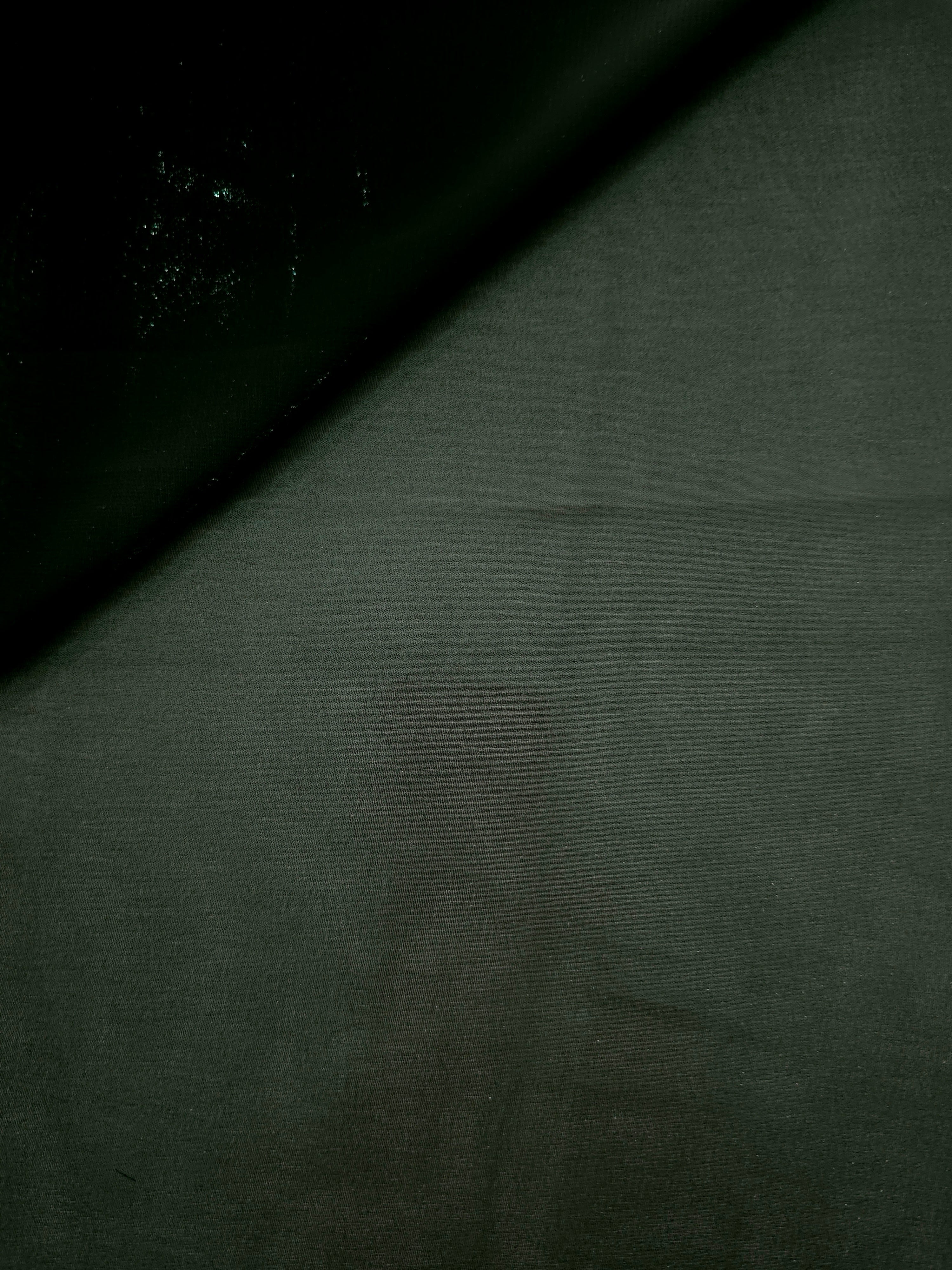 Deep forest soft draping view of liquid metallic shimmer chiffon fabric, highlighting fluid folds and reflective surface