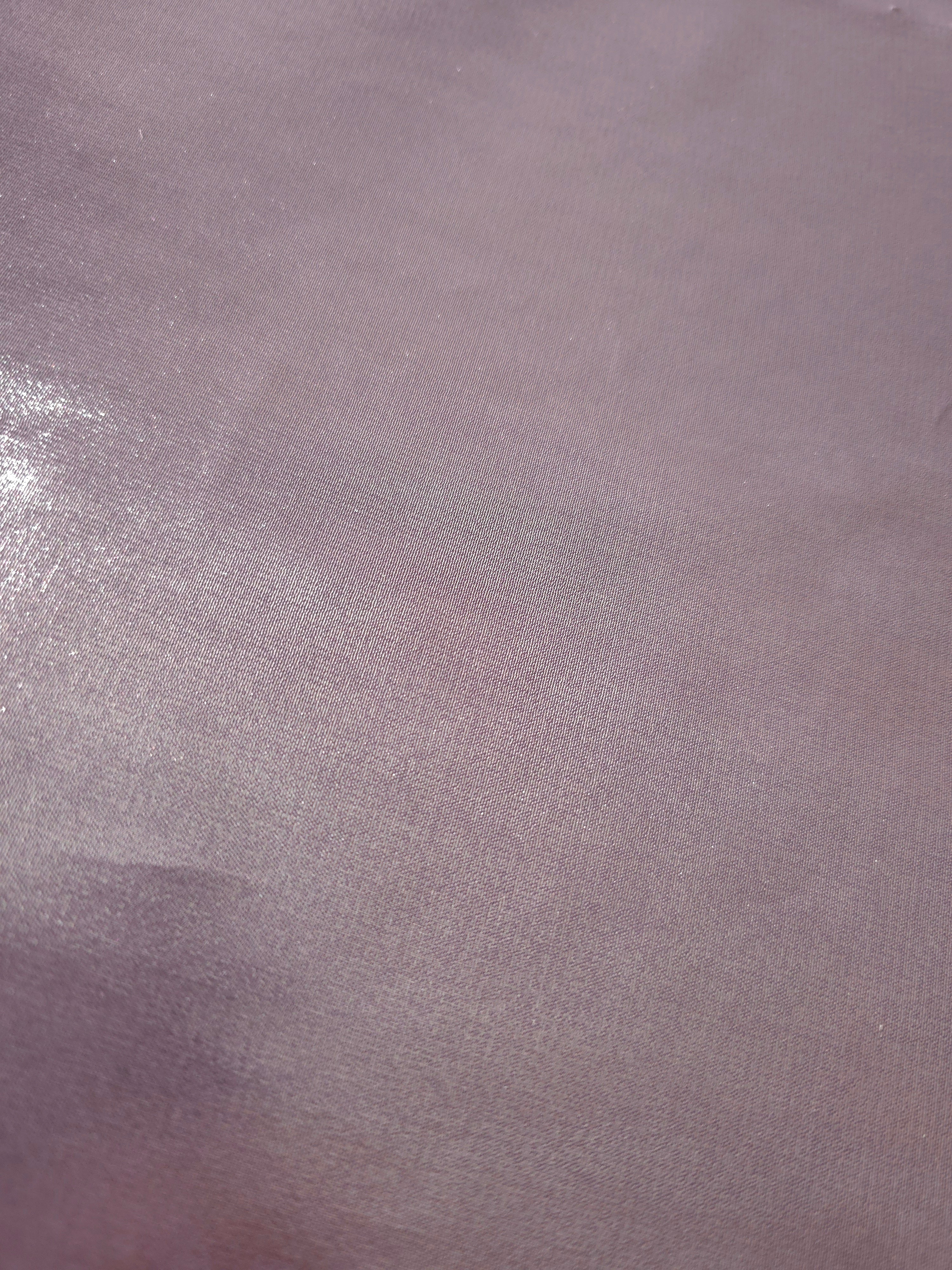 Dusty lilac fold detail of liquid metallic shimmer chiffon fabric, showing lightweight reflective fabric texture and drape