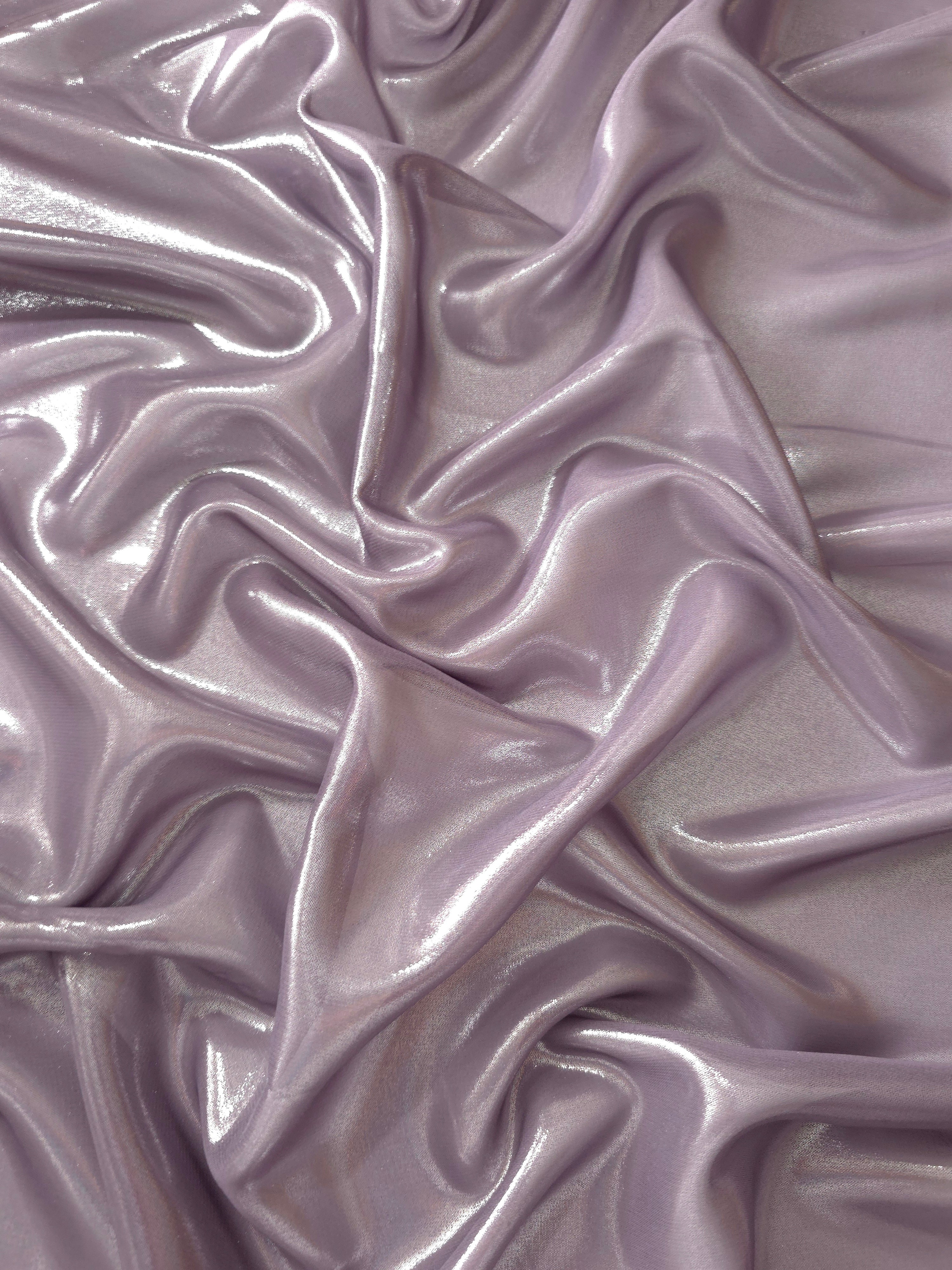 Dusty lilac surface detail of liquid metallic shimmer chiffon fabric, showing lightweight reflective fabric texture and drape