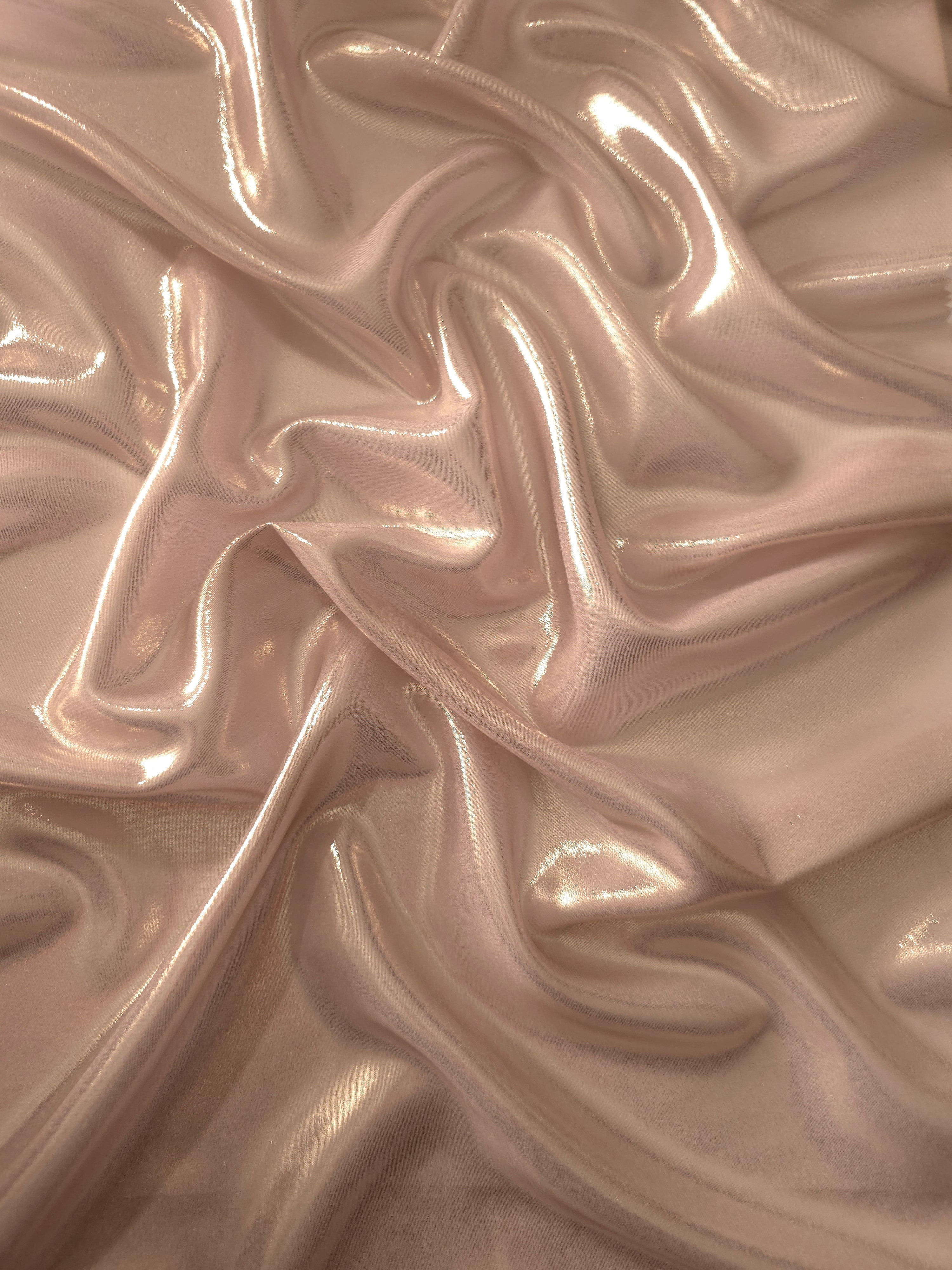 Dusty rose surface detail of liquid metallic shimmer chiffon fabric, showing lightweight reflective fabric texture and drape