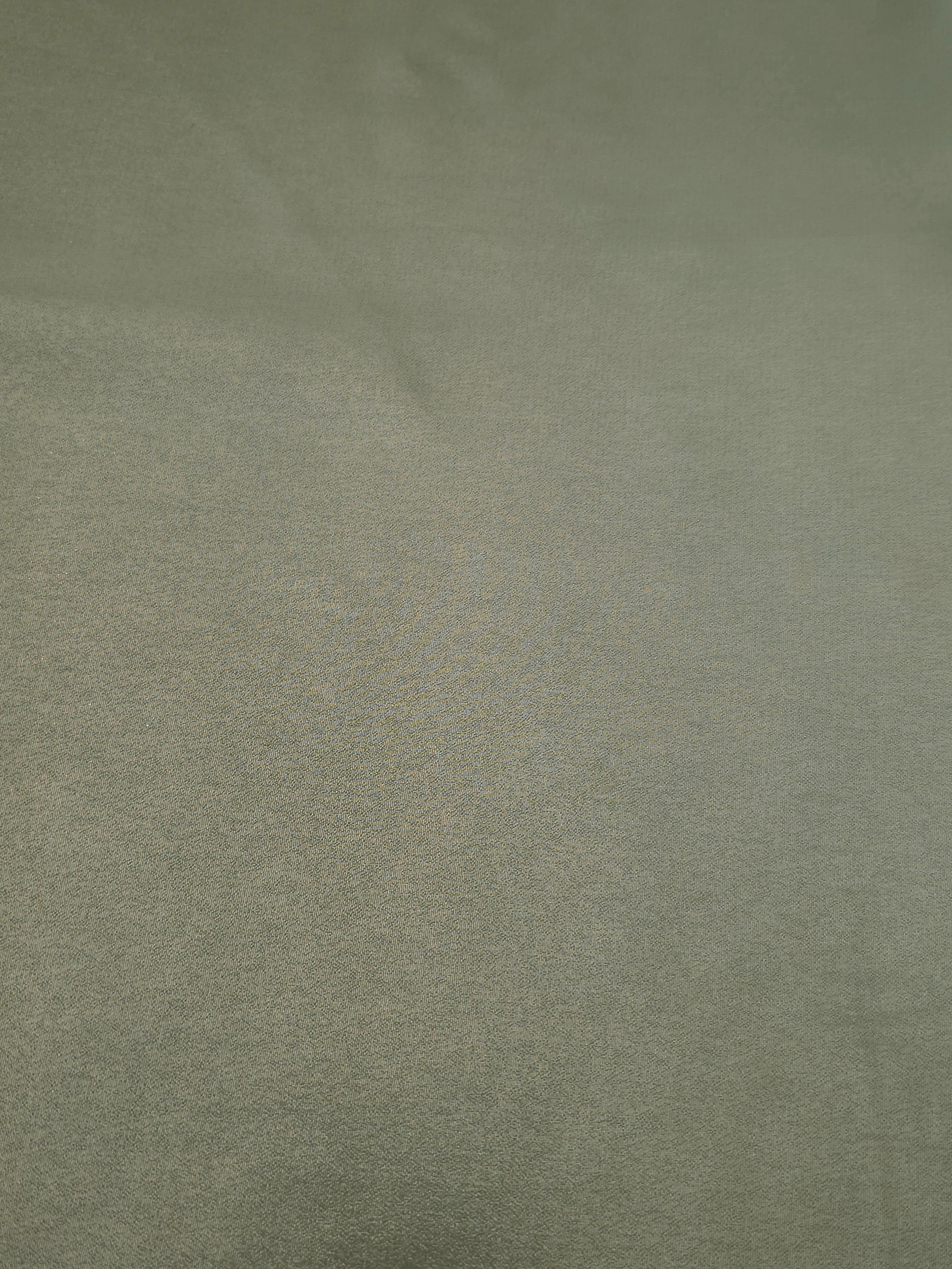 Forest green fold detail view of liquid metallic shimmer chiffon fabric, highlighting fluid folds and reflective surface