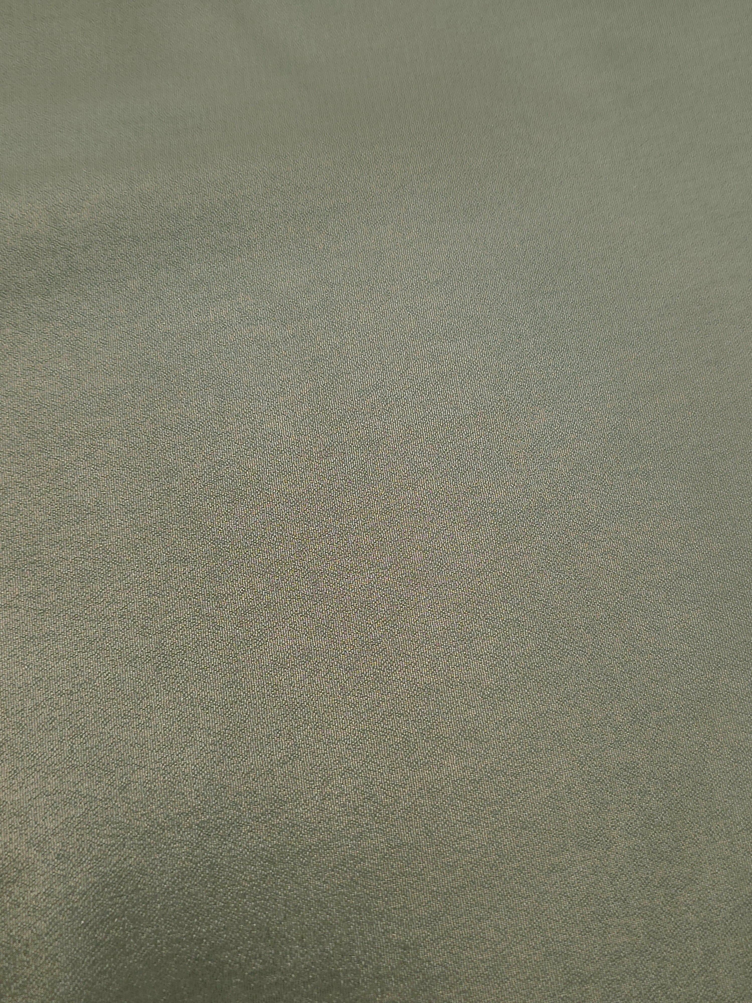 Forest green soft draping view of liquid metallic shimmer chiffon fabric, highlighting fluid folds and reflective surface