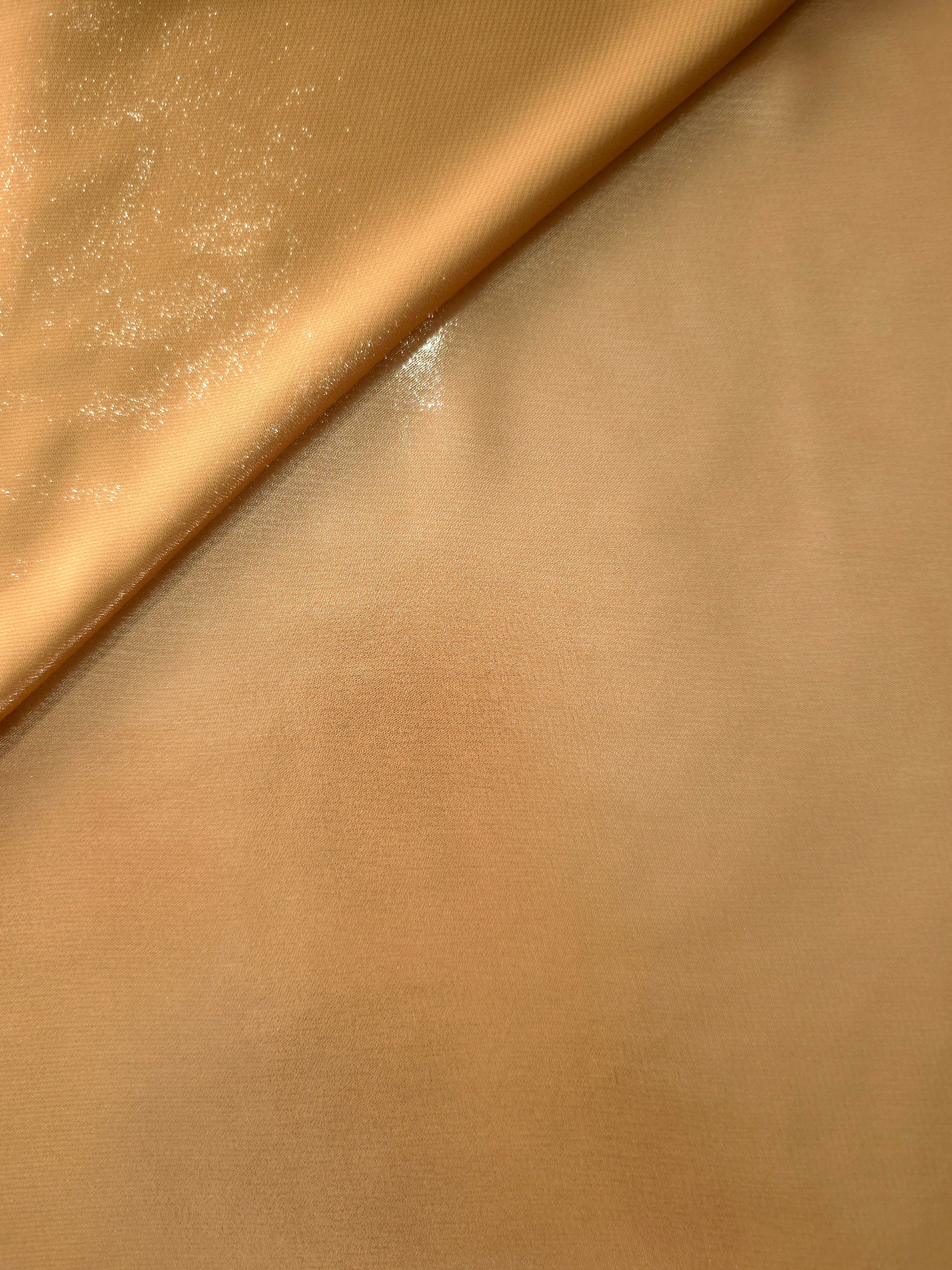 Golden sand soft draping view of liquid metallic shimmer chiffon fabric, highlighting fluid folds and reflective surface