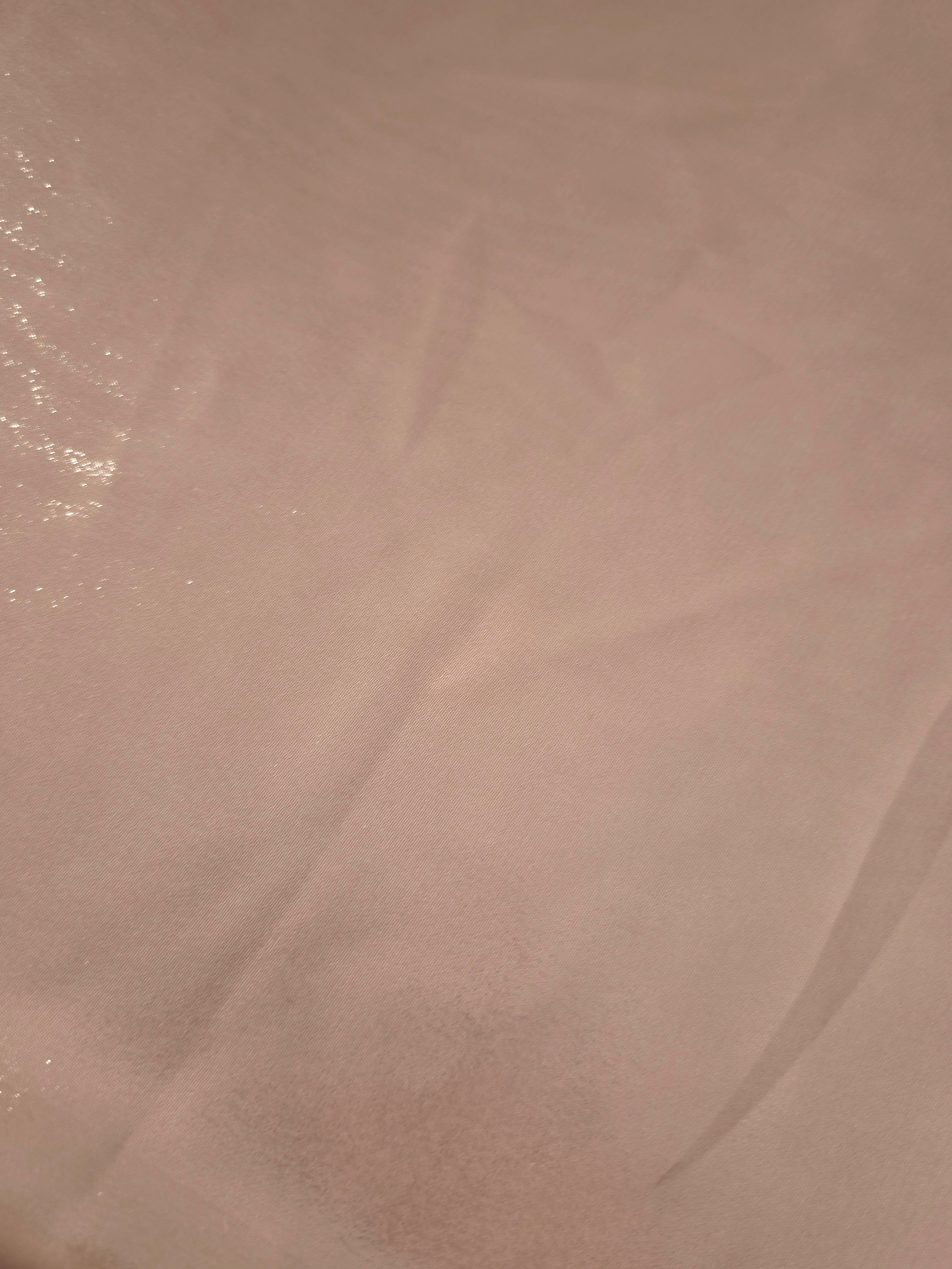 Mauve haze fold detail of liquid metallic shimmer chiffon fabric, showing lightweight reflective fabric texture and drape
