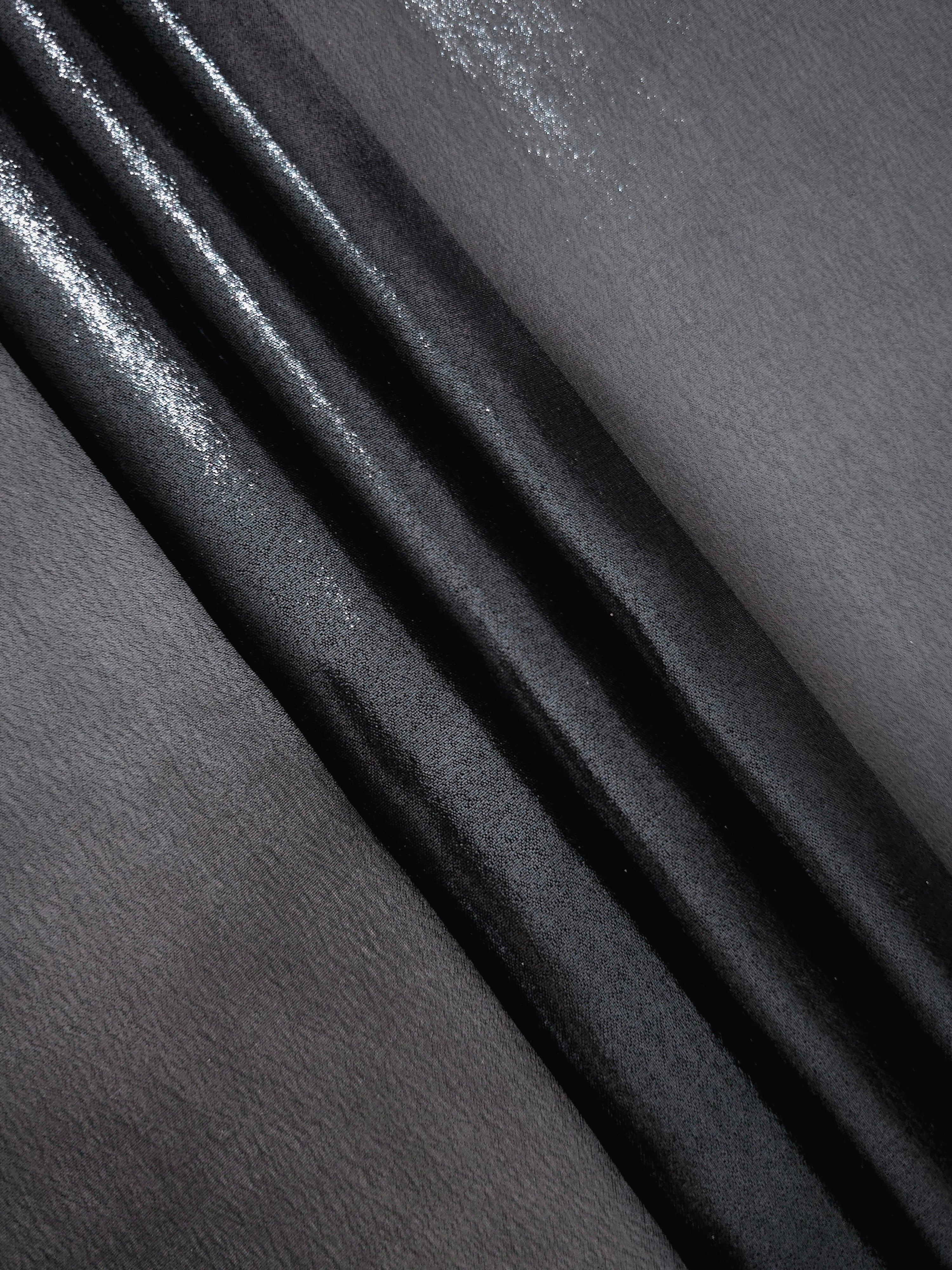 Midnight navy flowing folds view of liquid metallic shimmer chiffon fabric, highlighting fluid folds and reflective surface