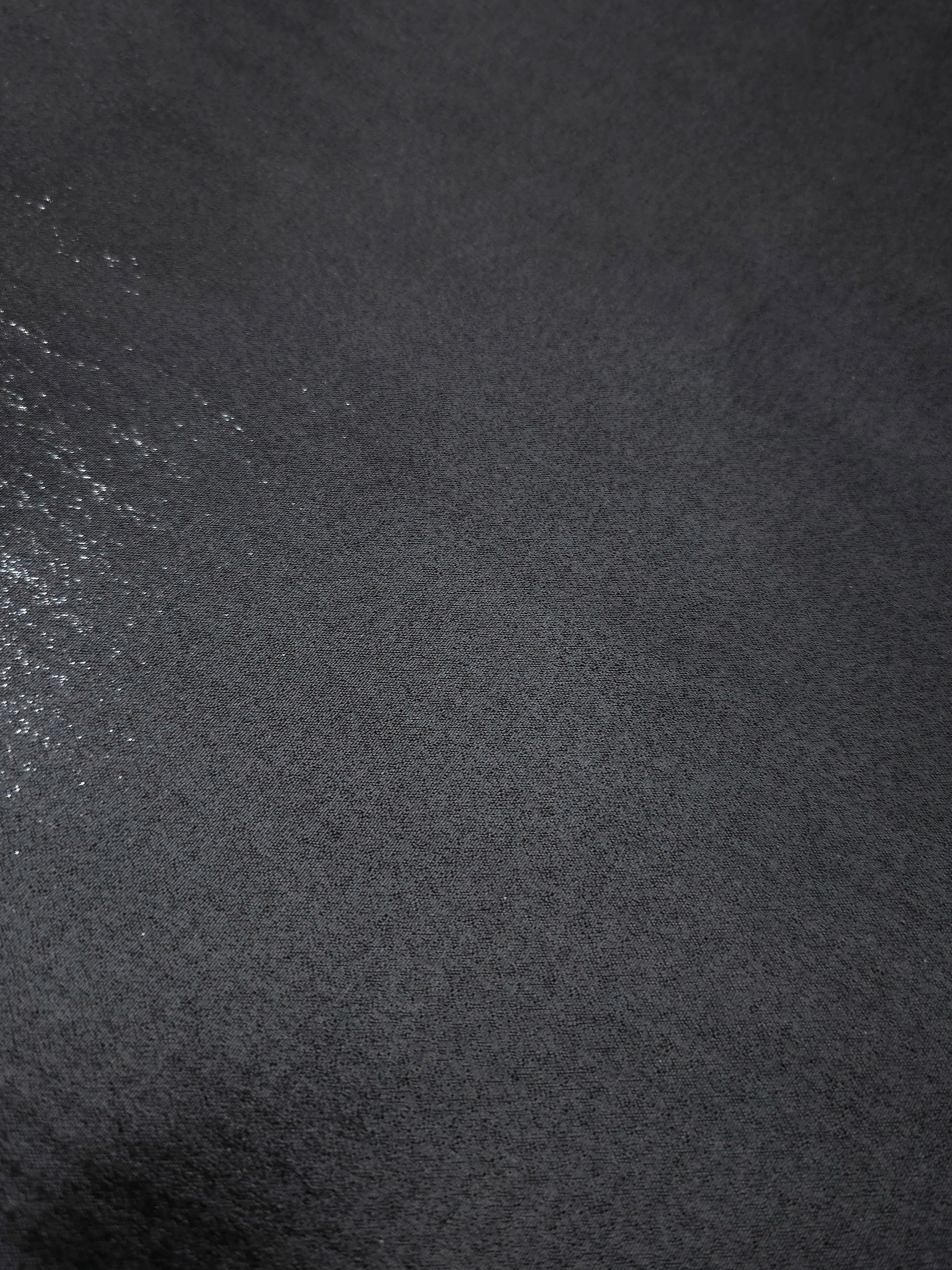 Midnight navy fold detail view of liquid metallic shimmer chiffon fabric, highlighting fluid folds and reflective surface