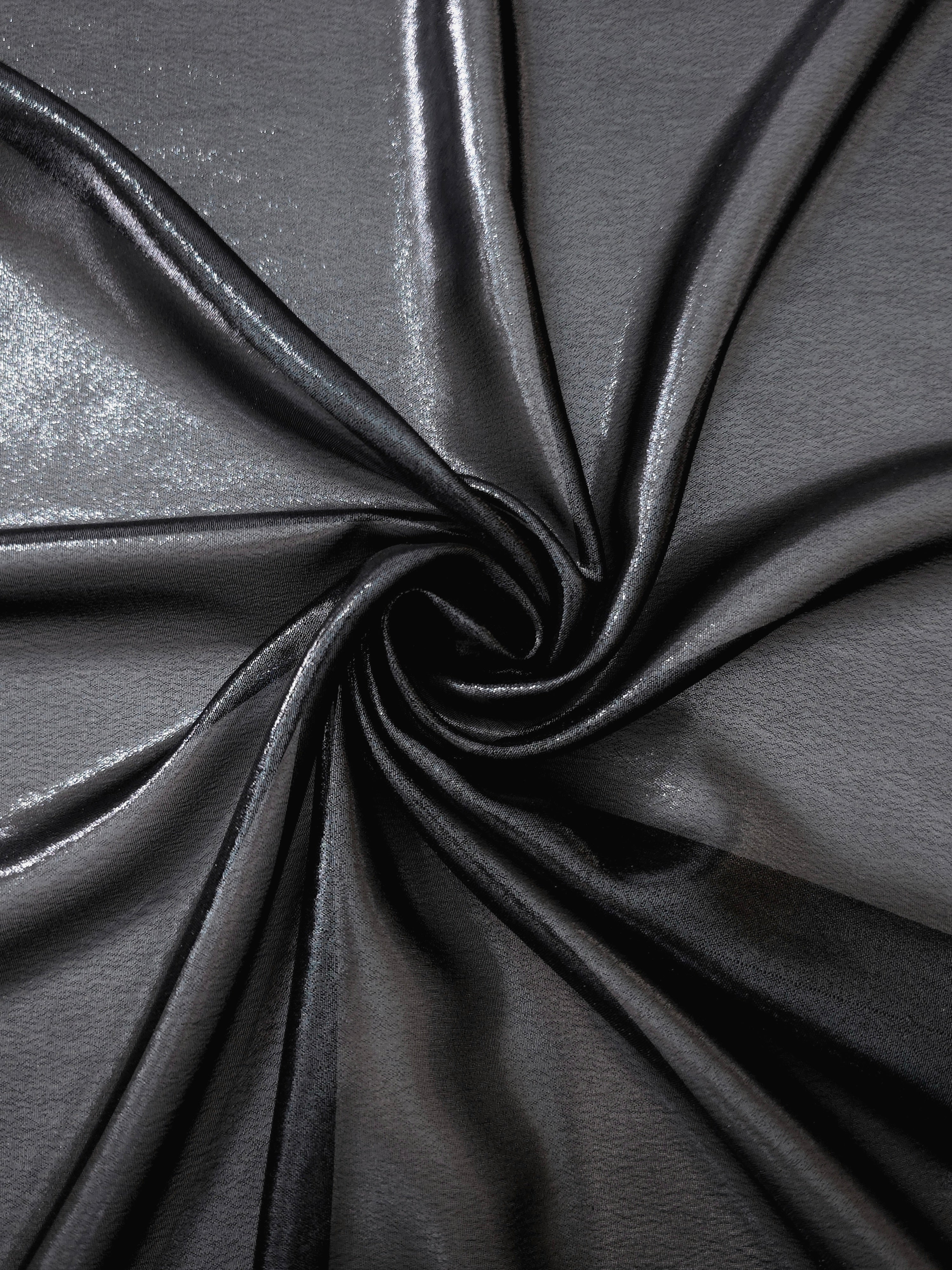 Midnight navy shimmer close up view of liquid metallic shimmer chiffon fabric, highlighting fluid folds and reflective surface