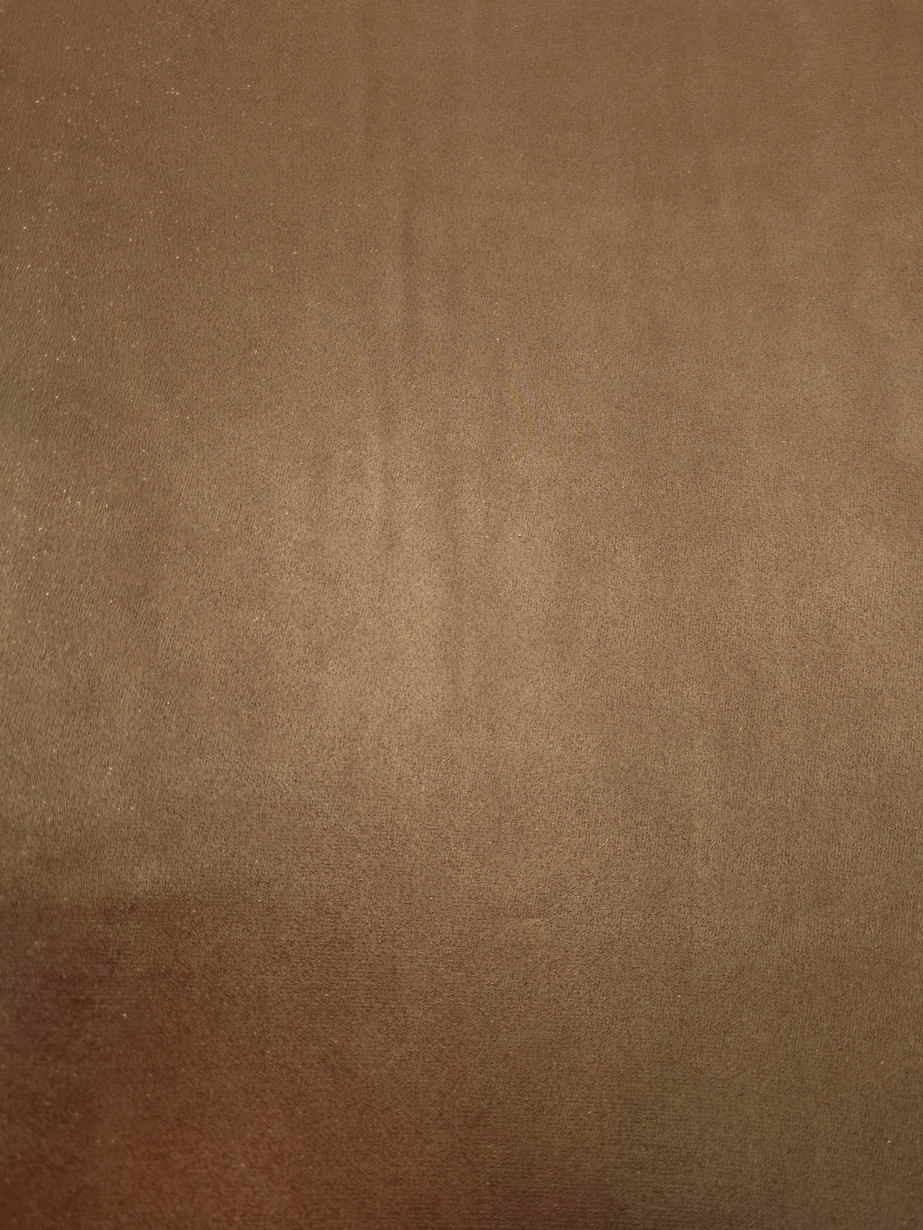 Mocha brown fabric overview view of liquid metallic shimmer chiffon fabric, highlighting fluid folds and reflective surface