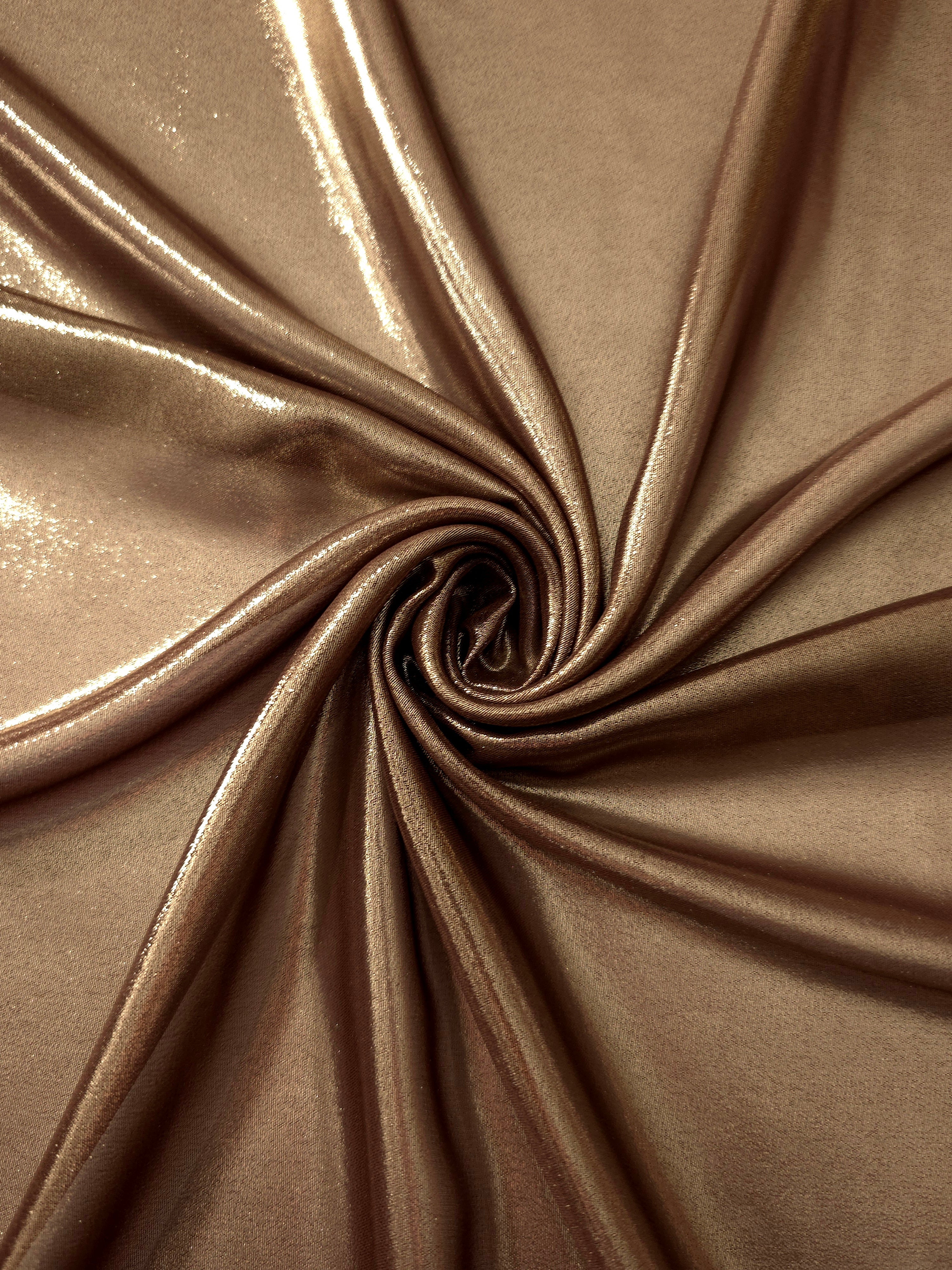 Mocha brown shimmer close up view of liquid metallic shimmer chiffon fabric, highlighting fluid folds and reflective surface