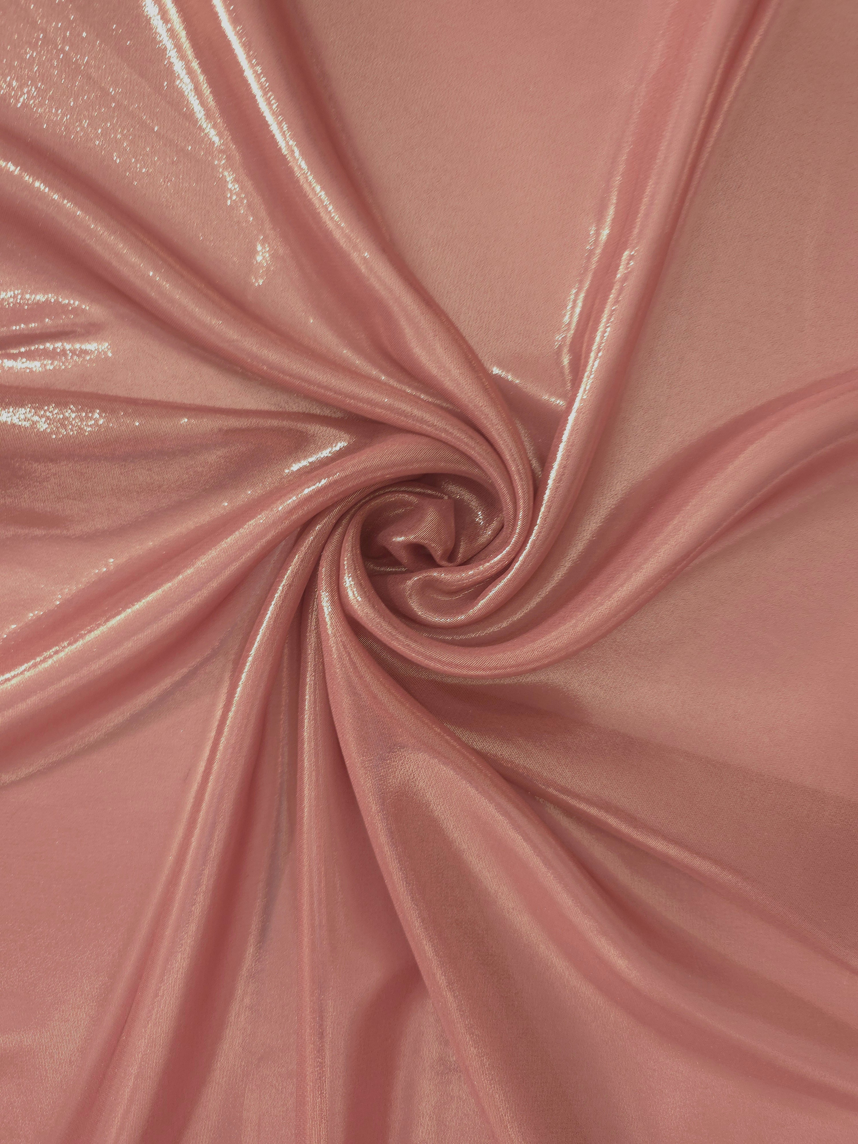 Muted rose shimmer close up view of liquid metallic shimmer chiffon fabric, highlighting fluid folds and reflective surface