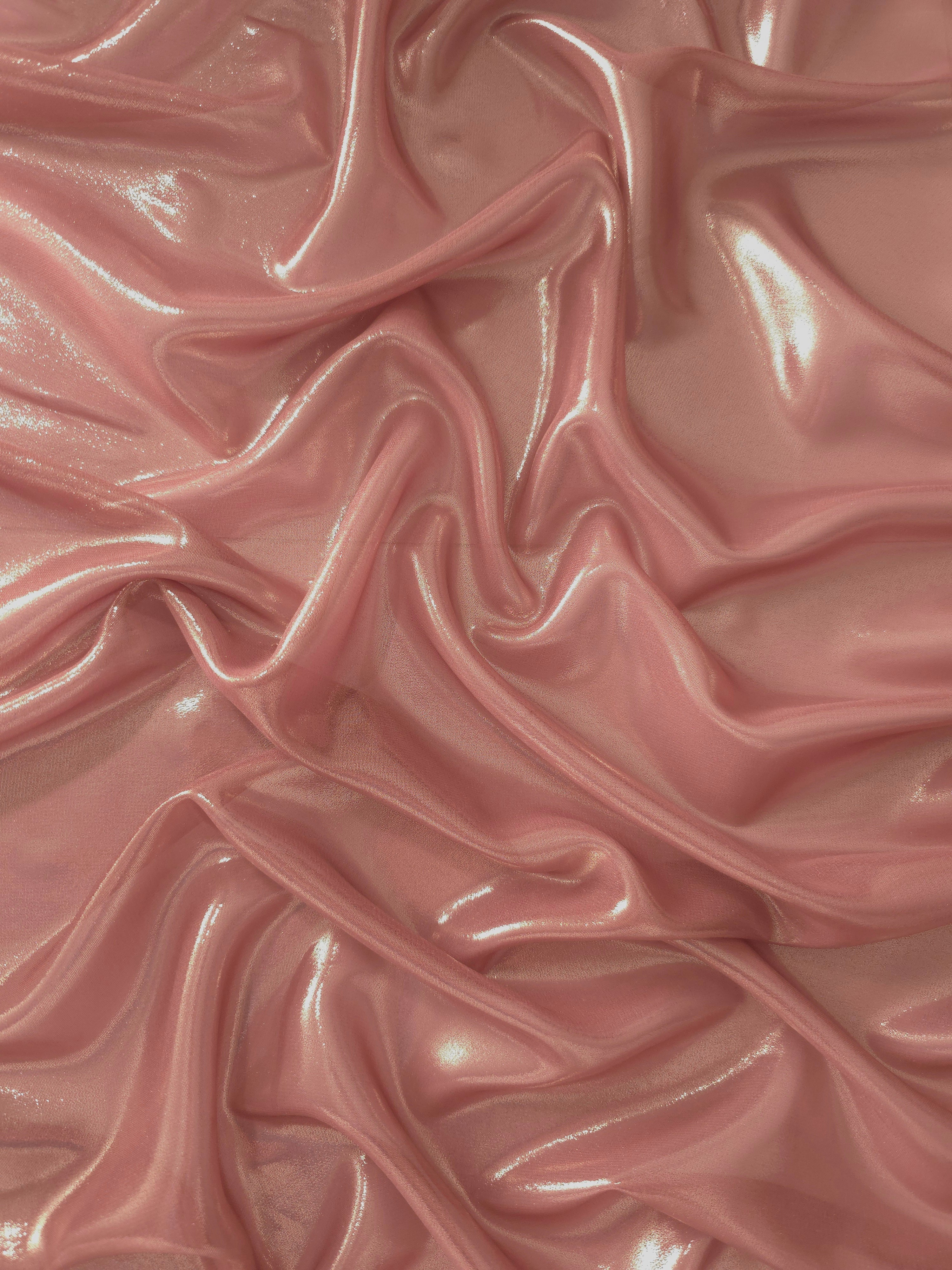 Muted rose soft draping view of liquid metallic shimmer chiffon fabric, highlighting fluid folds and reflective surface