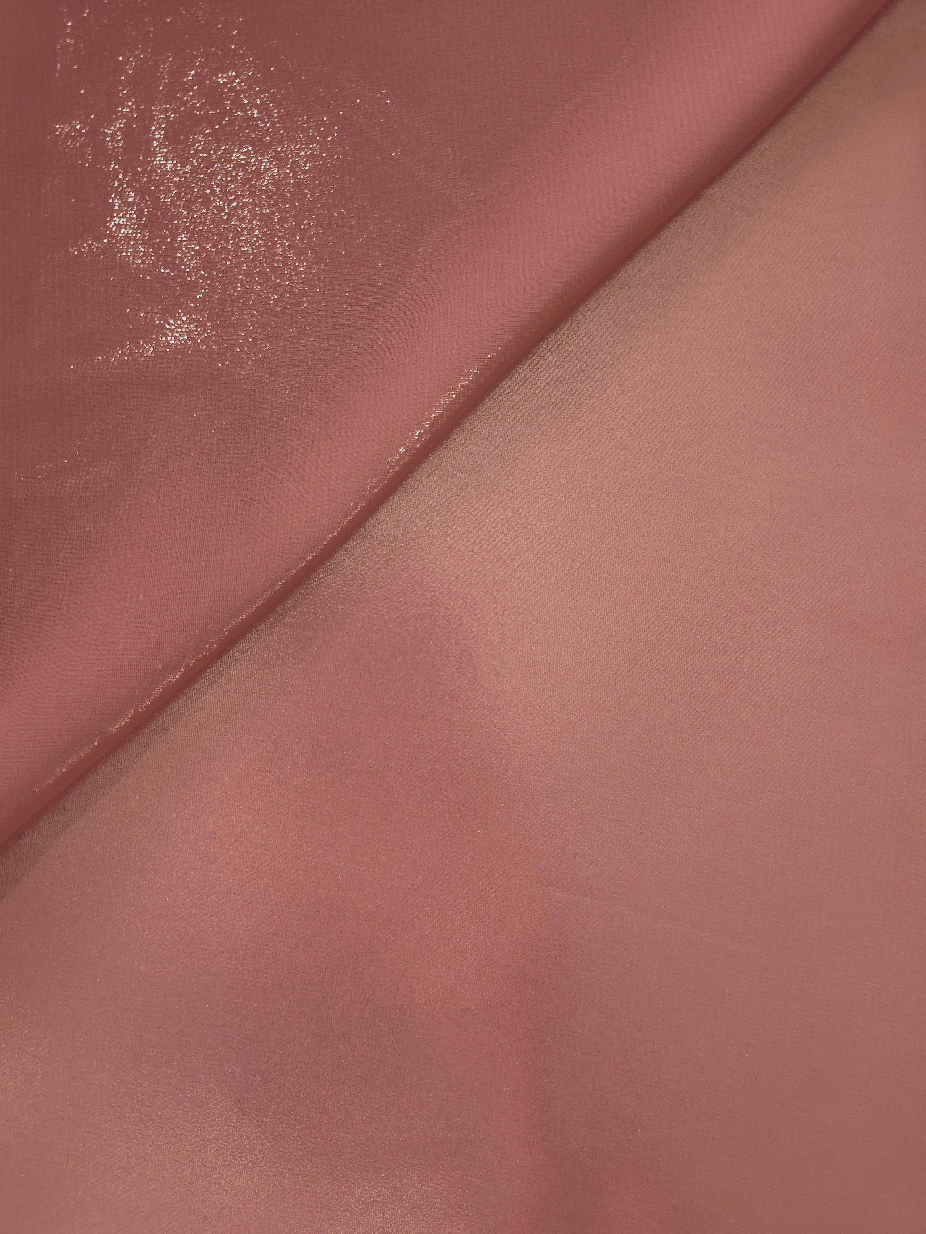 Muted rose surface detail view of liquid metallic shimmer chiffon fabric, highlighting fluid folds and reflective surface
