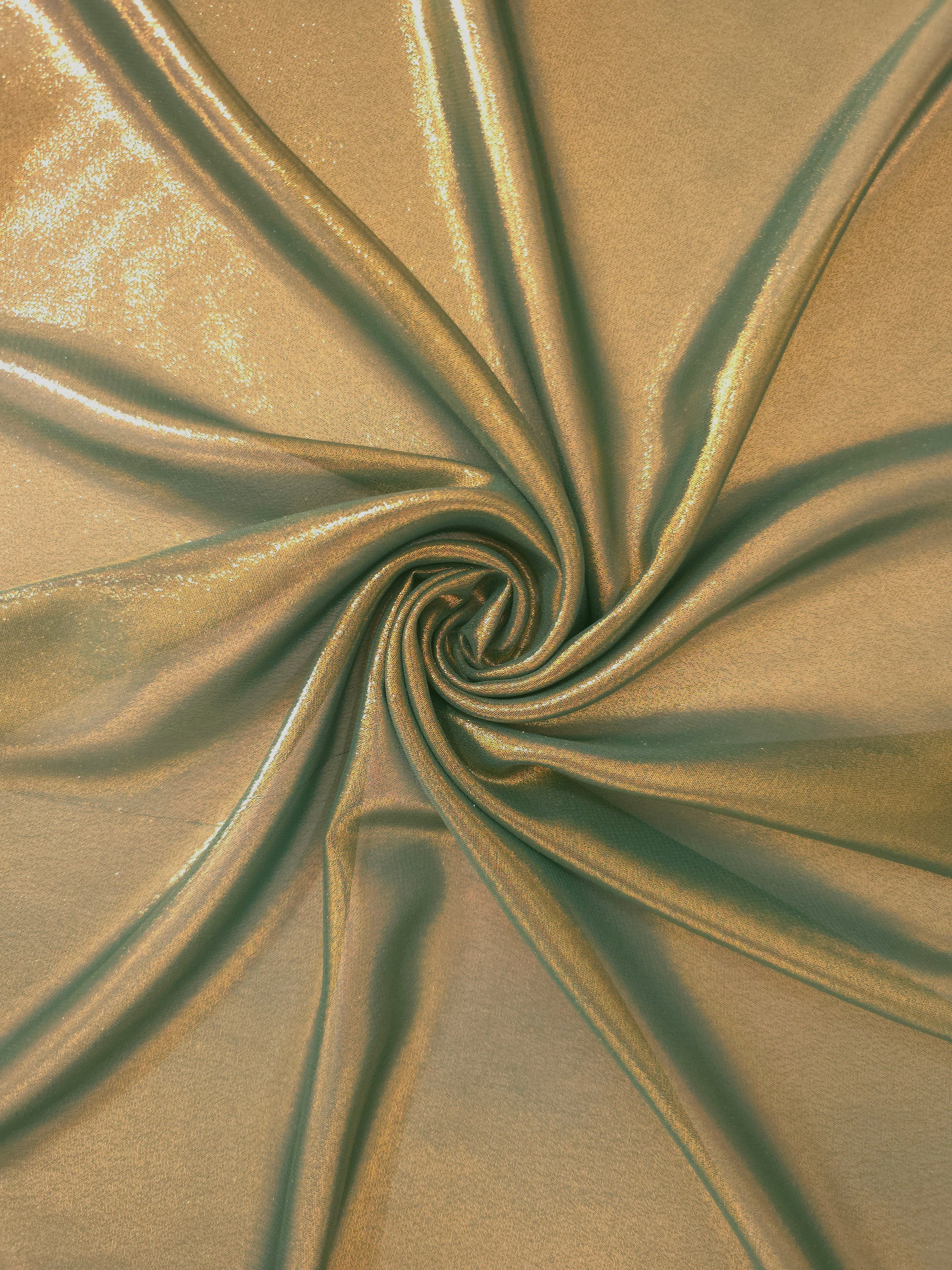Olive gold shimmer close up view of liquid metallic shimmer chiffon fabric, highlighting fluid folds and reflective surface