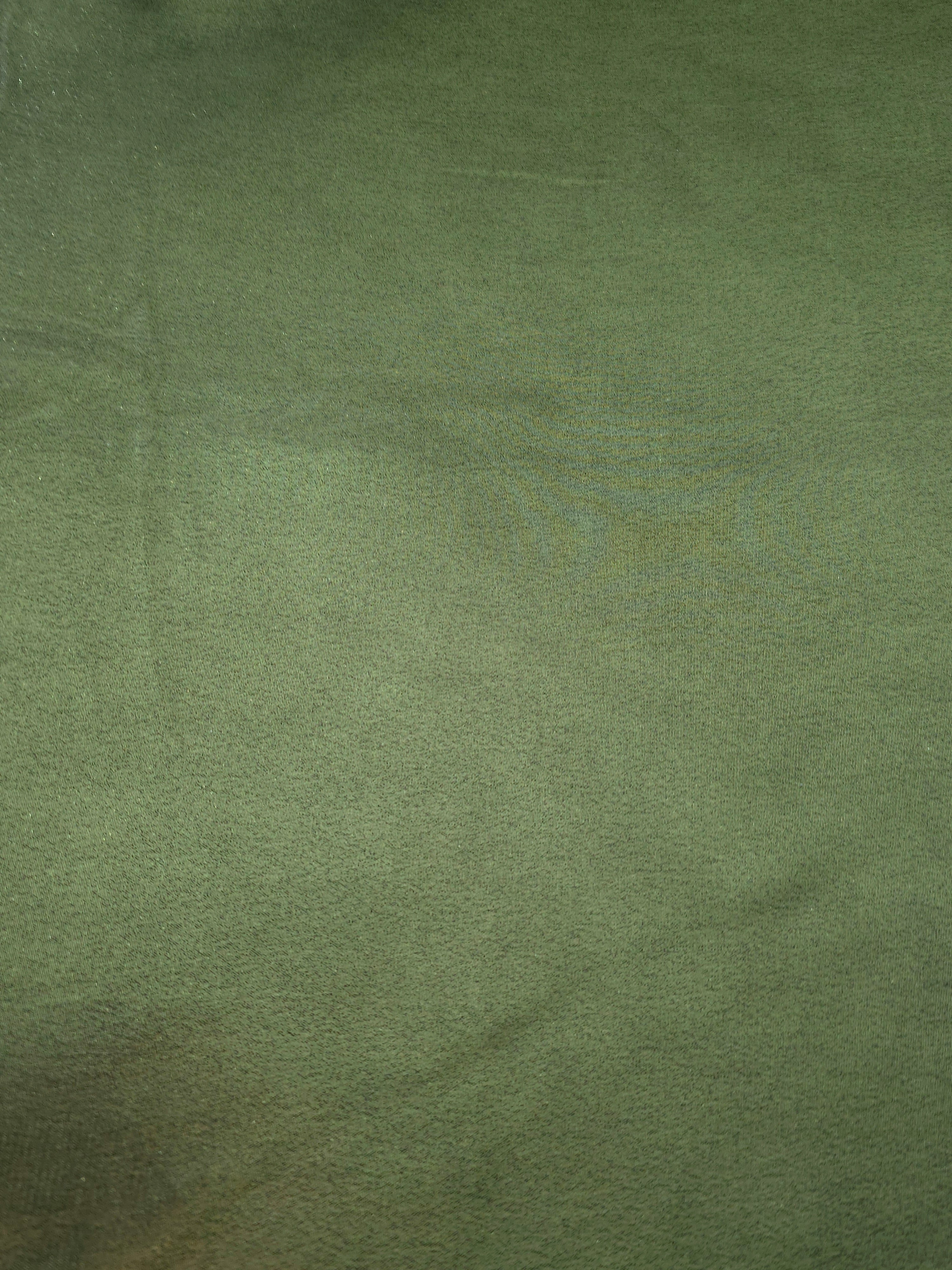 Olive green fabric overview view of liquid metallic shimmer chiffon fabric, highlighting fluid folds and reflective surface