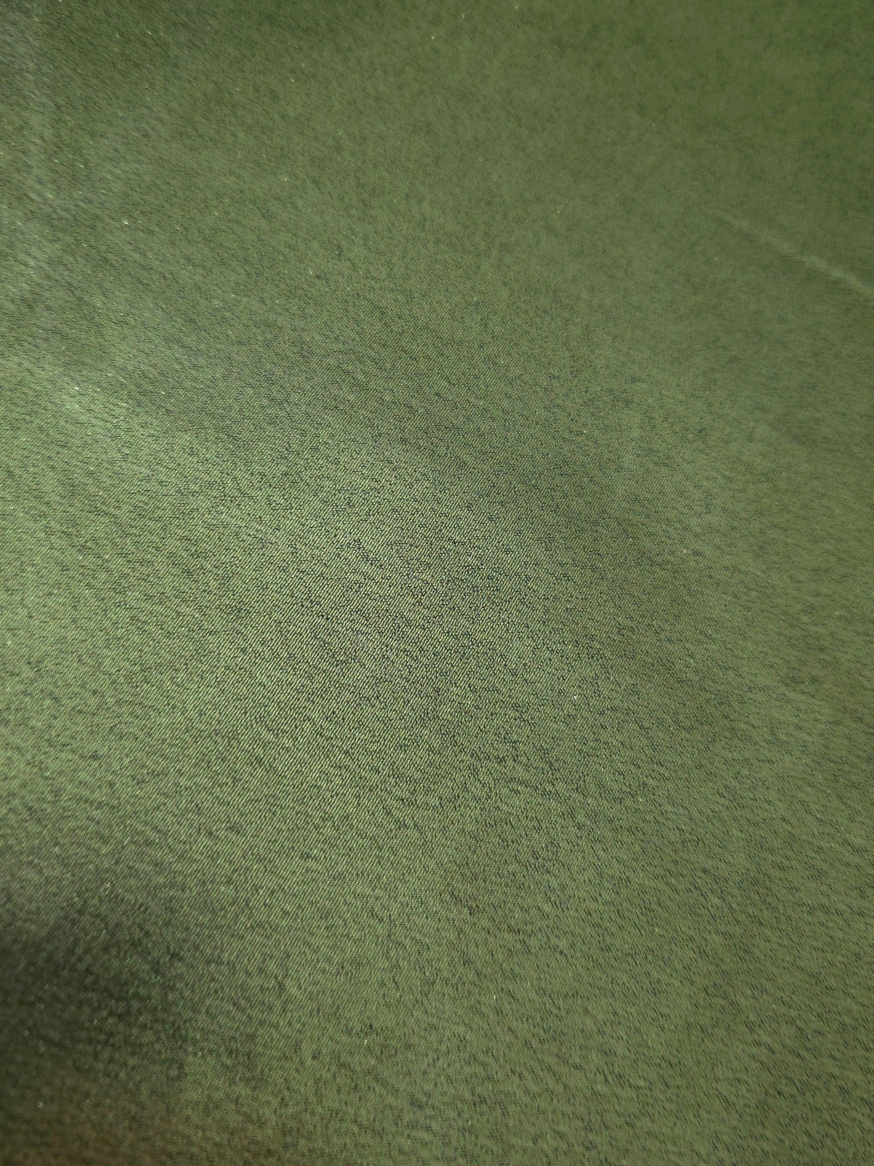 Olive green fold detail view of liquid metallic shimmer chiffon fabric, highlighting fluid folds and reflective surface