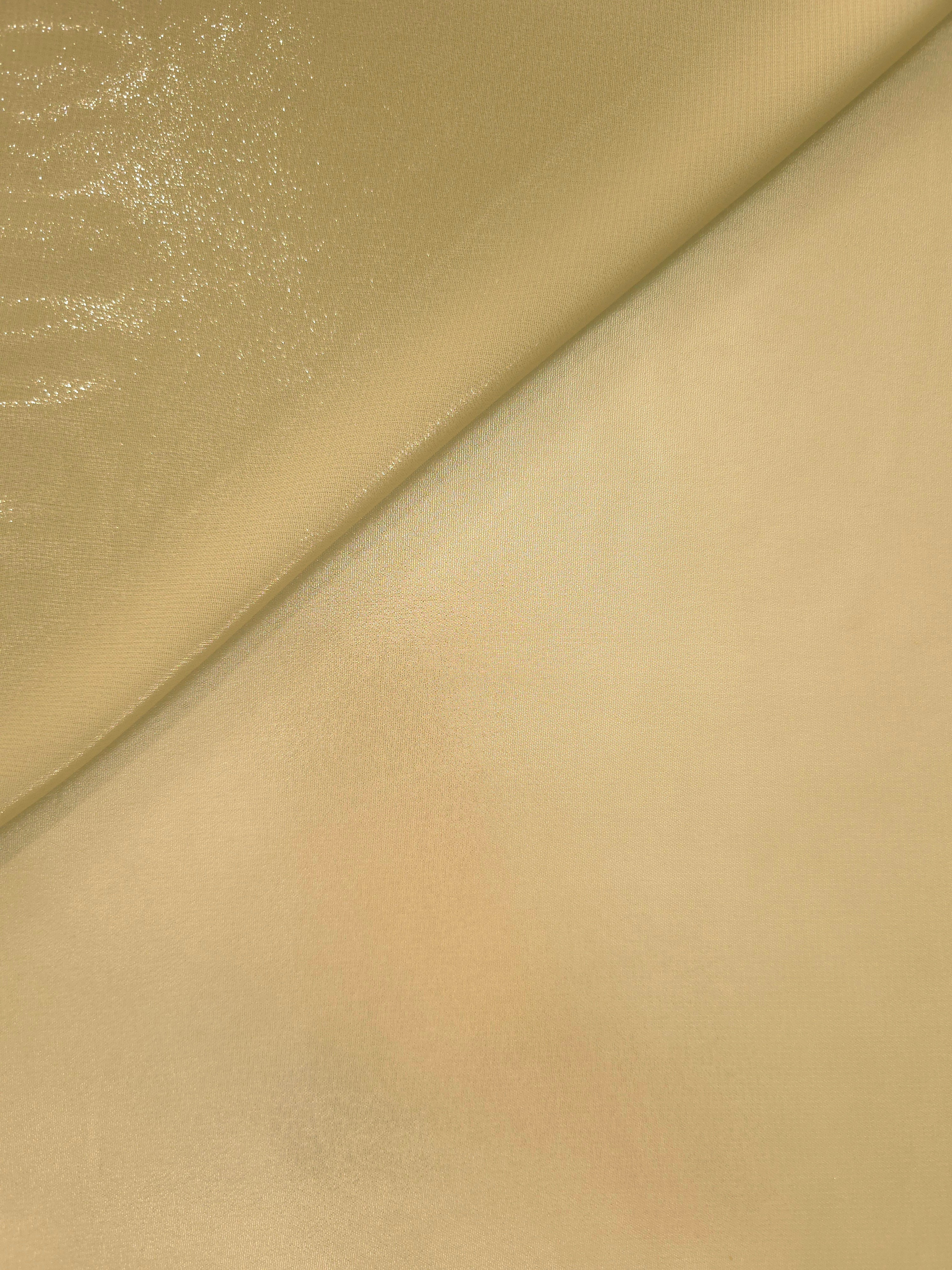 Pale gold soft draping view of liquid metallic shimmer chiffon fabric, highlighting fluid folds and reflective surface