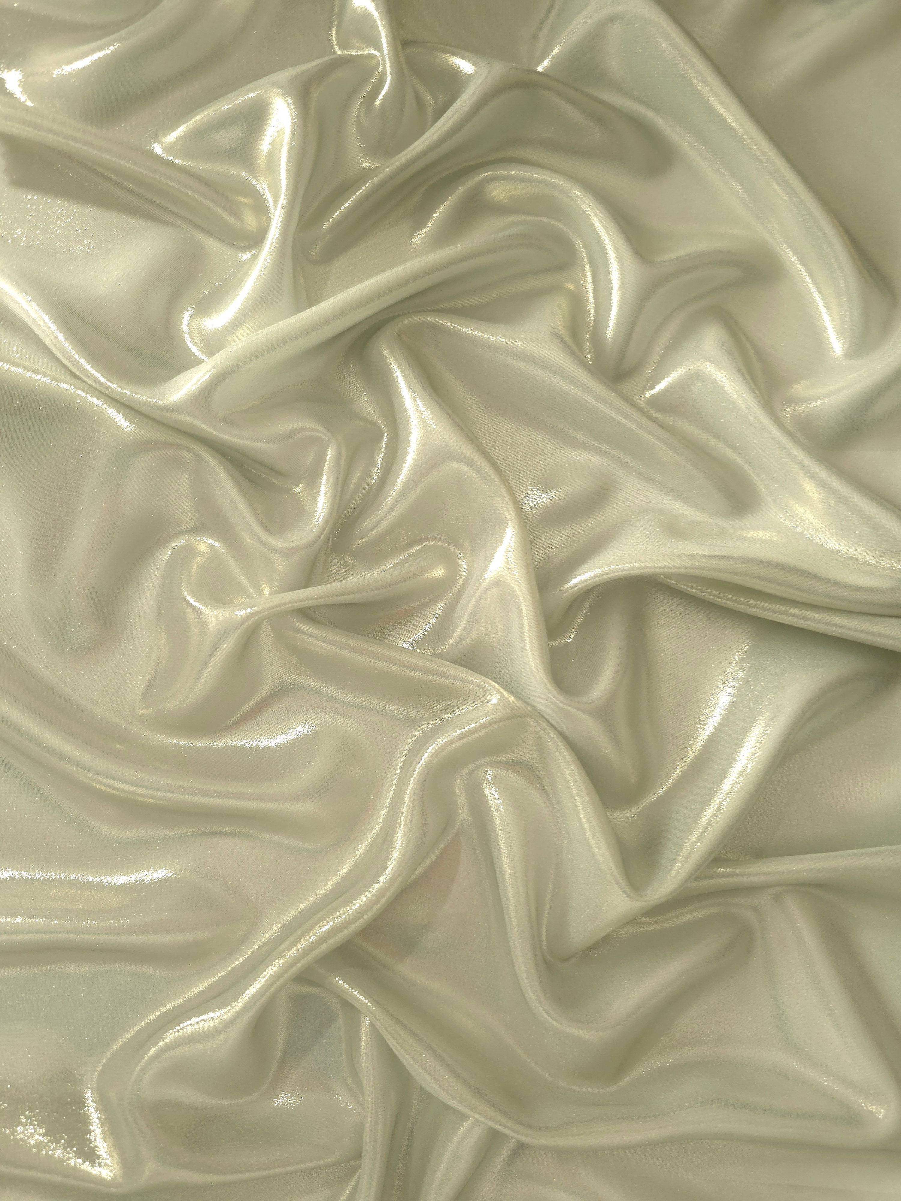 Pale pistachio surface detail of liquid metallic shimmer chiffon fabric, showing lightweight reflective fabric texture and drape