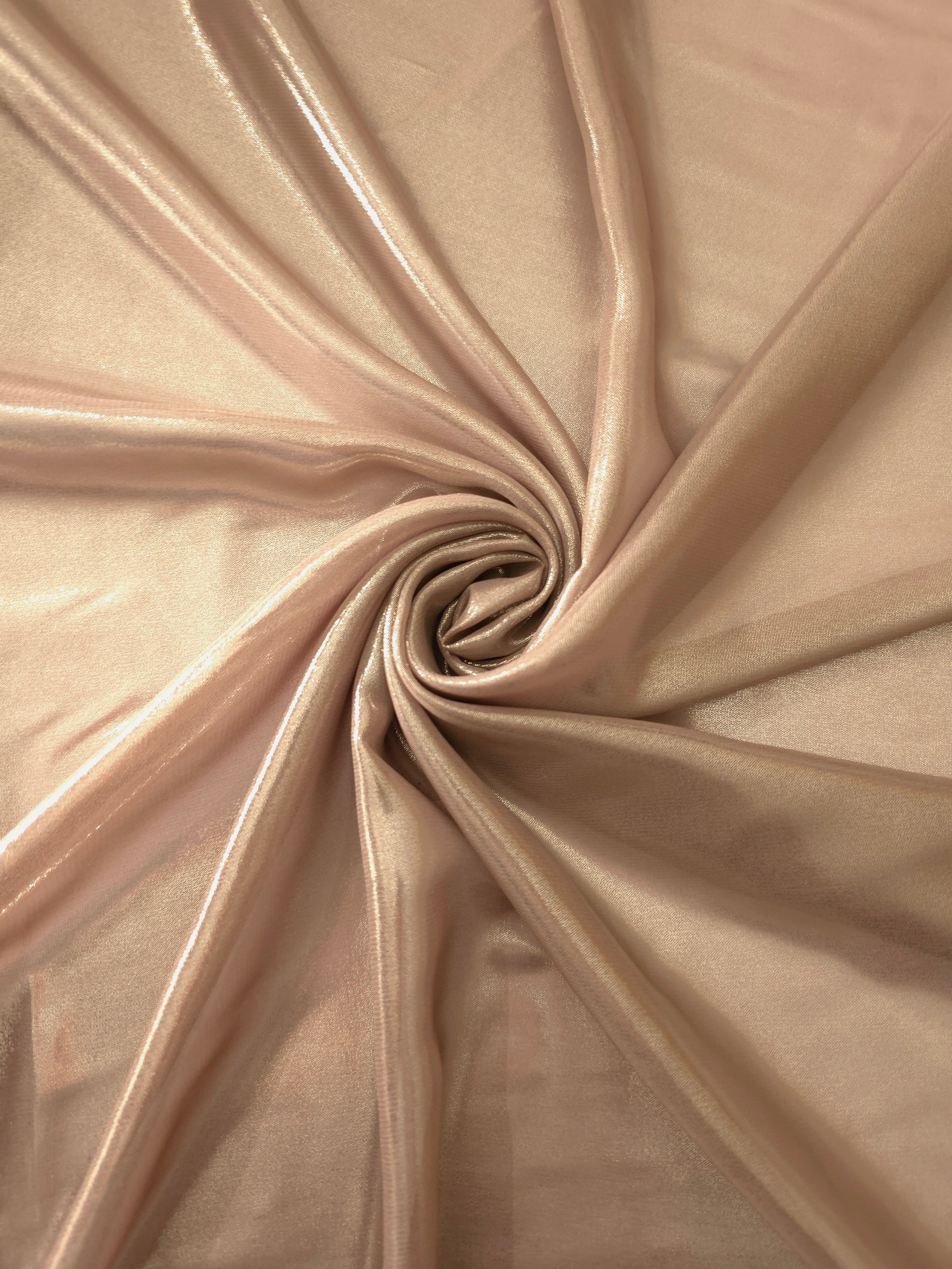 Peach champagne shimmer close up view of liquid metallic shimmer chiffon fabric, highlighting fluid folds and reflective surface
