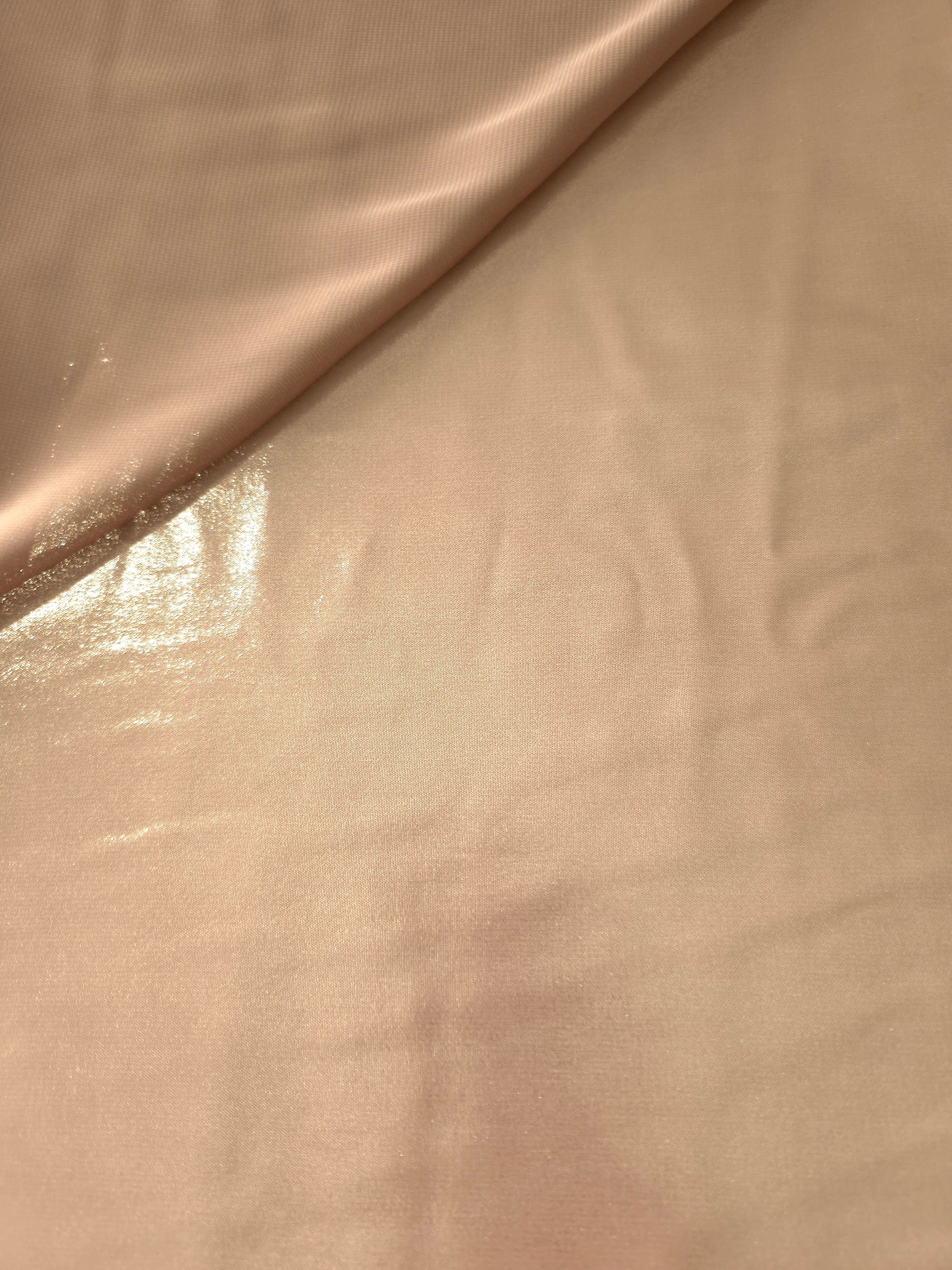 Peach champagne soft draping view of liquid metallic shimmer chiffon fabric, highlighting fluid folds and reflective surface