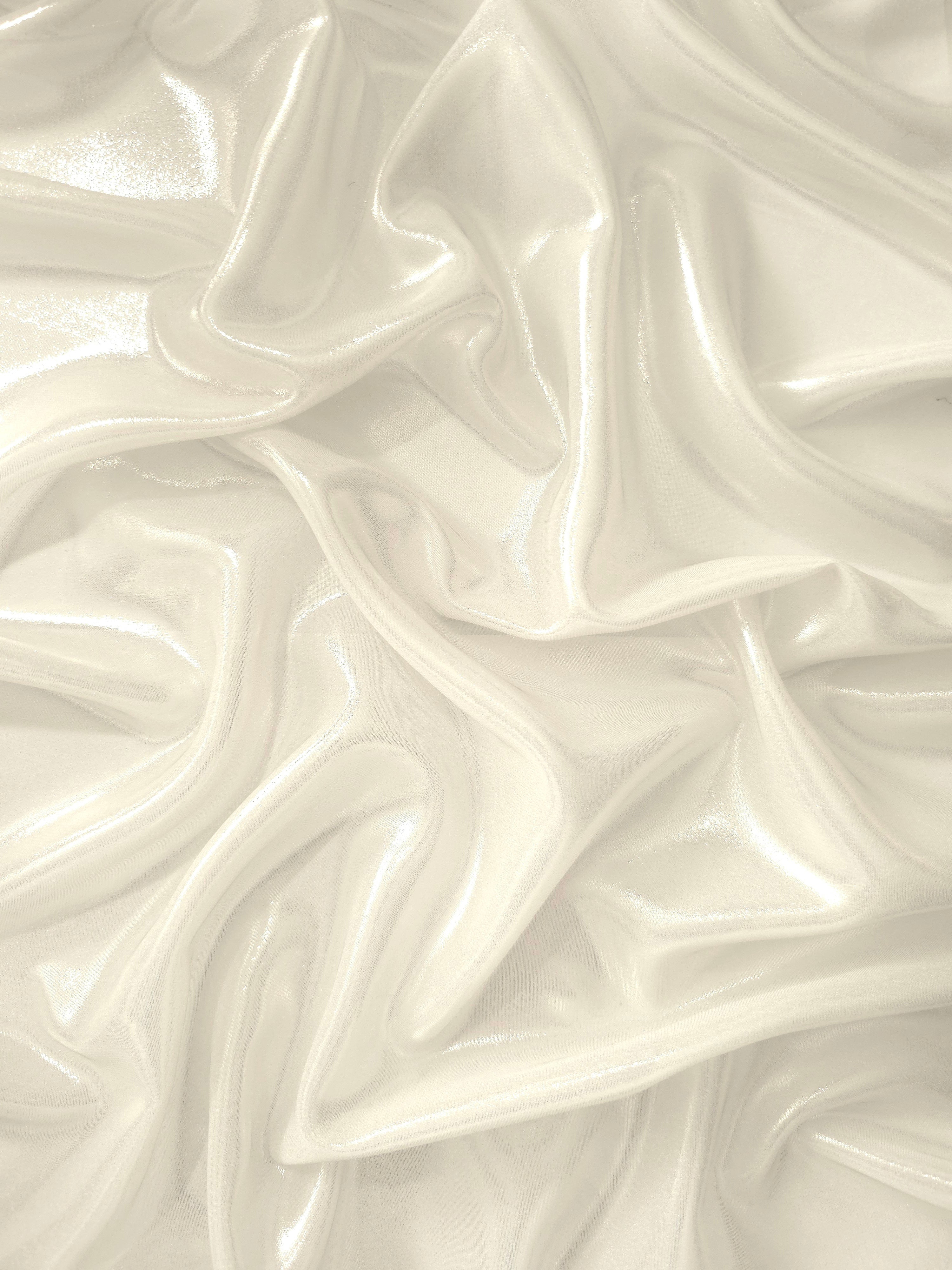 Pearl white surface detail of liquid metallic shimmer chiffon fabric, showing lightweight reflective fabric texture and drape